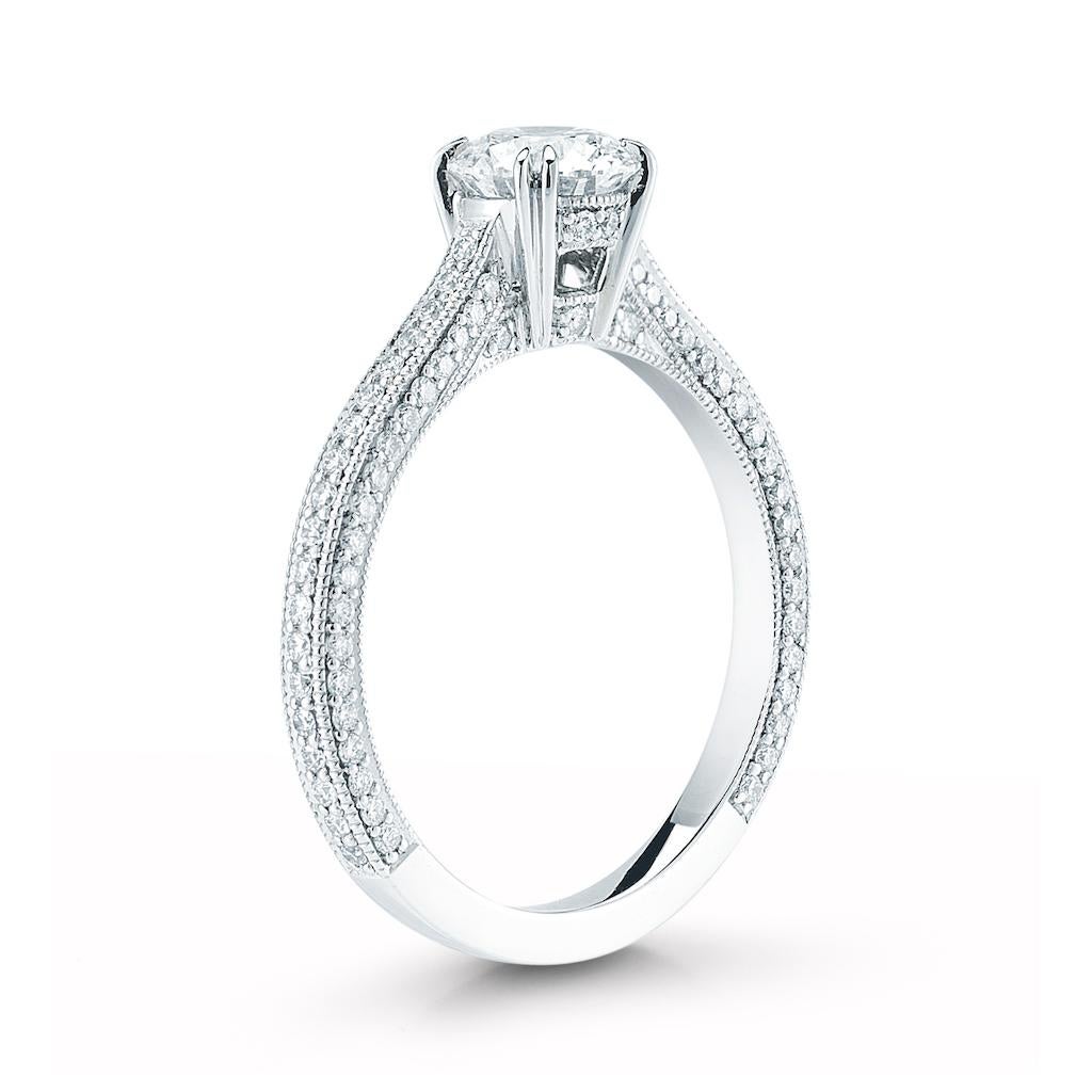 This diamond ring features a round brilliant cut center diamond and a micro pave band. The center stone is available in all sizes, colors and qualities. Setting available in platinum, gold, white gold, and rose gold. 

Presented here is a beautiful