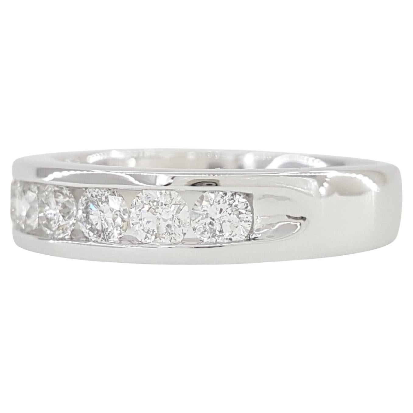 A stunning 14K White Gold Round Brilliant Cut Diamond Channel Set Wedding/Anniversary Band/Ring is on offer. Weighing 5.3 grams and sized at 7, the ring boasts a width of 4.9 mm. The design is adorned with 9 Natural Round Brilliant Cut diamonds,