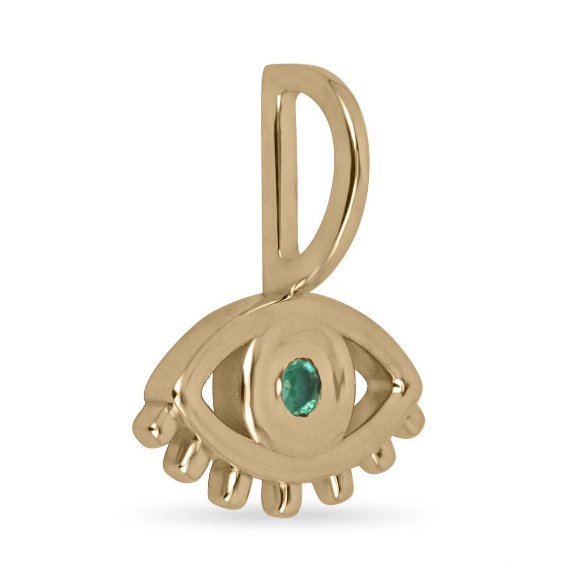 A gorgeous and dainty evil eye emerald pendant. This beautiful piece features a petite natural round cut emerald in the very center of the eye. The evil eye has been used throughout the centuries to ward off curses or malicious intent. Many believed
