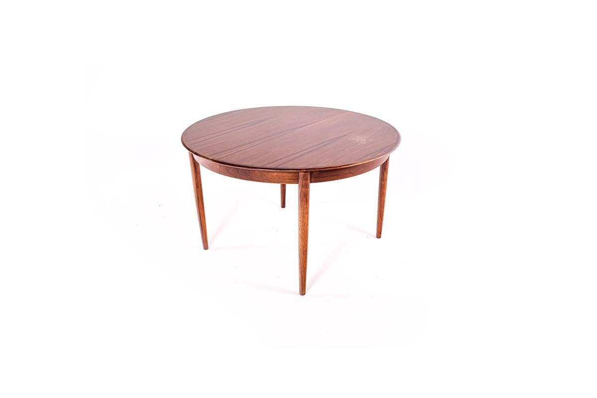 Classic Danish mid-century style round table with three leaves. Dimensions of each leaf 50 cm in rosewood veener. The table has a beautiful, rich, light rosewood wood grain on the top, matching perfectly in all elements.