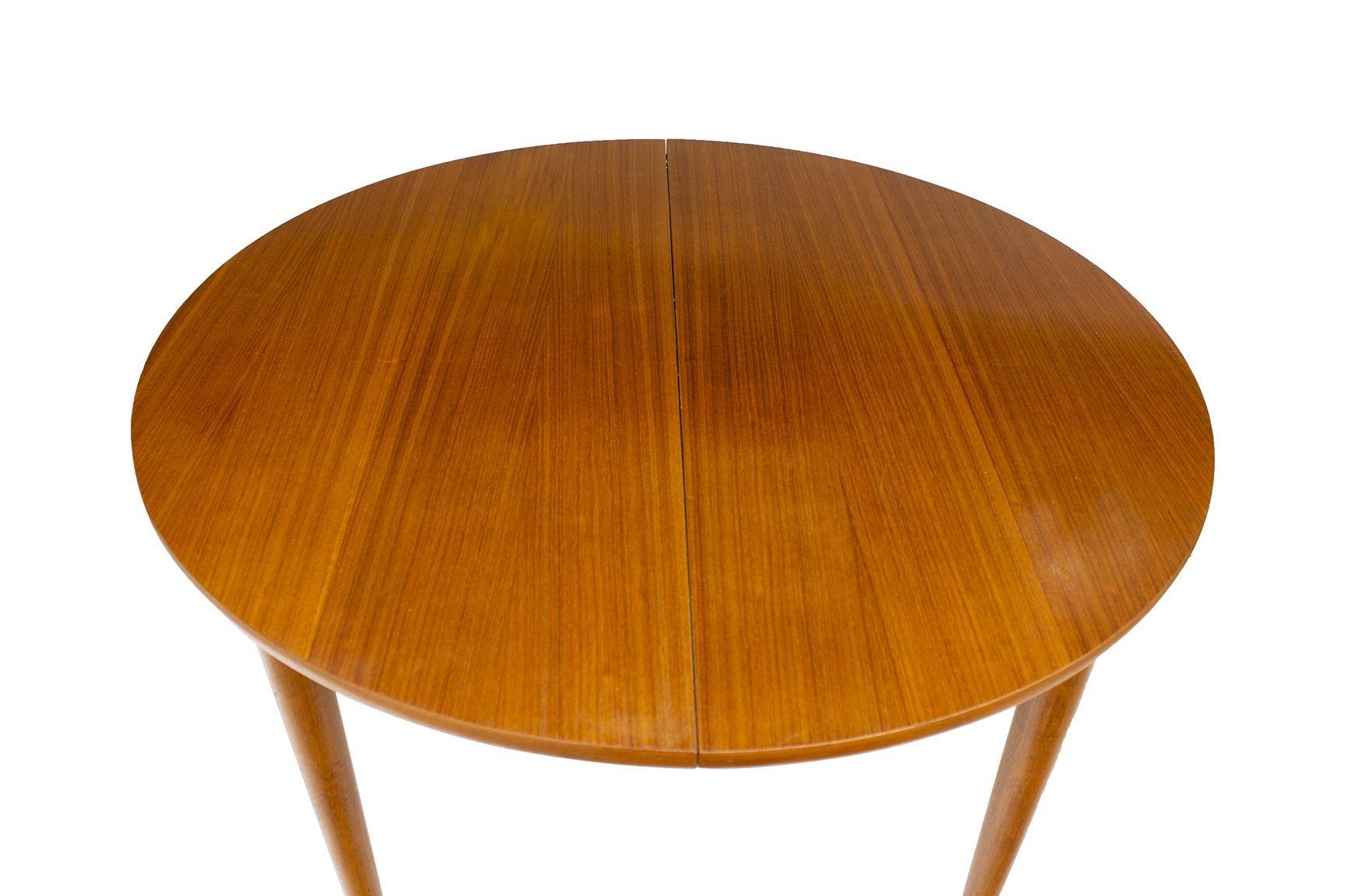 Likely Denmark or Sweden, 1960s
Round Scandinavian Teak Dining Table with Butterfly Leaf. Minimalist design though with subtle details. Great usable size, and adjustable via the pop-up, self-storing leaf. 
DIMENSIONS: 45 1/8