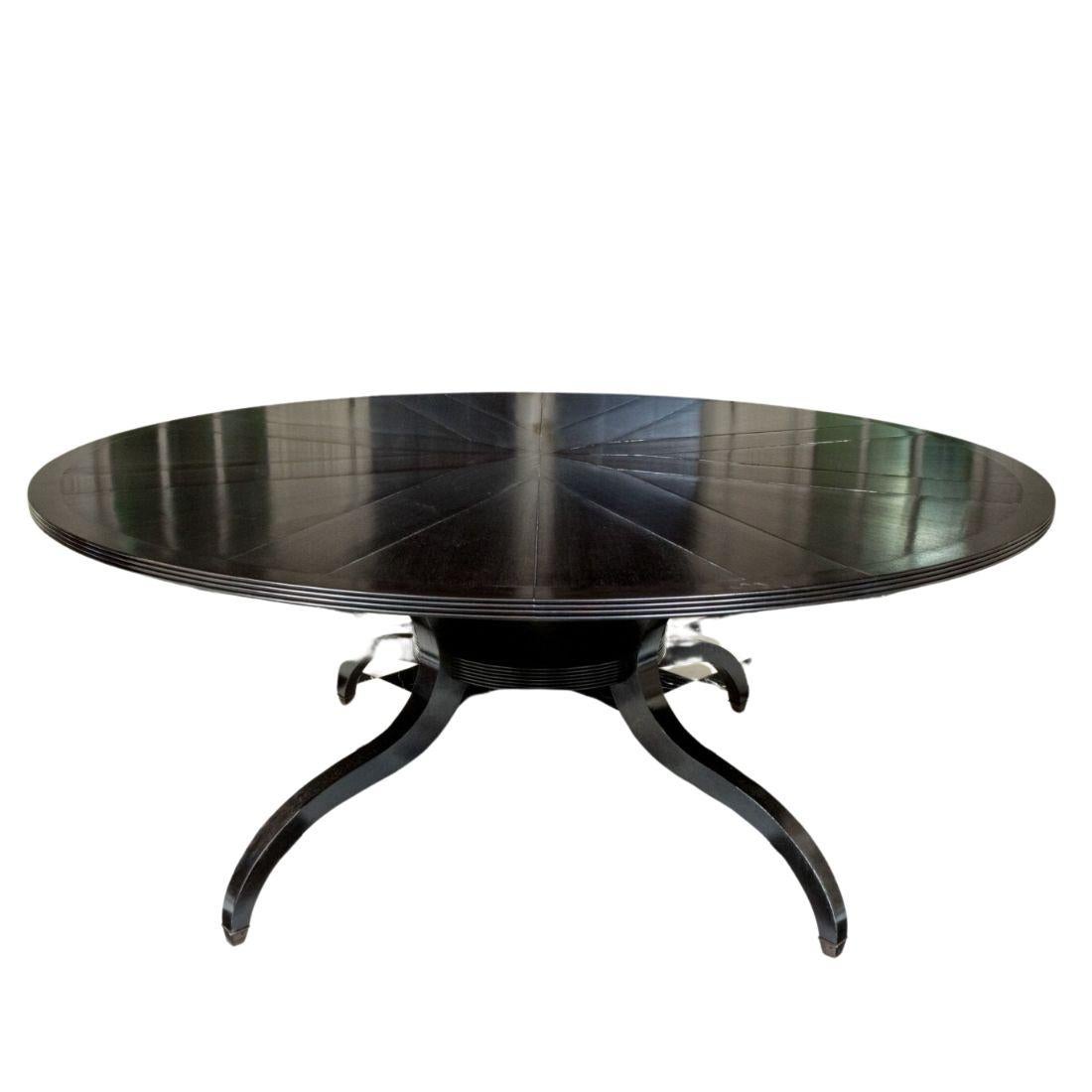 This elegant round dining table by David Iatesta showcases a stunning parquet design, finished in a rich espresso black-brown hue that adds depth and sophistication to any dining space. Its four sabre legs, gracefully tapering toward the floor, are
