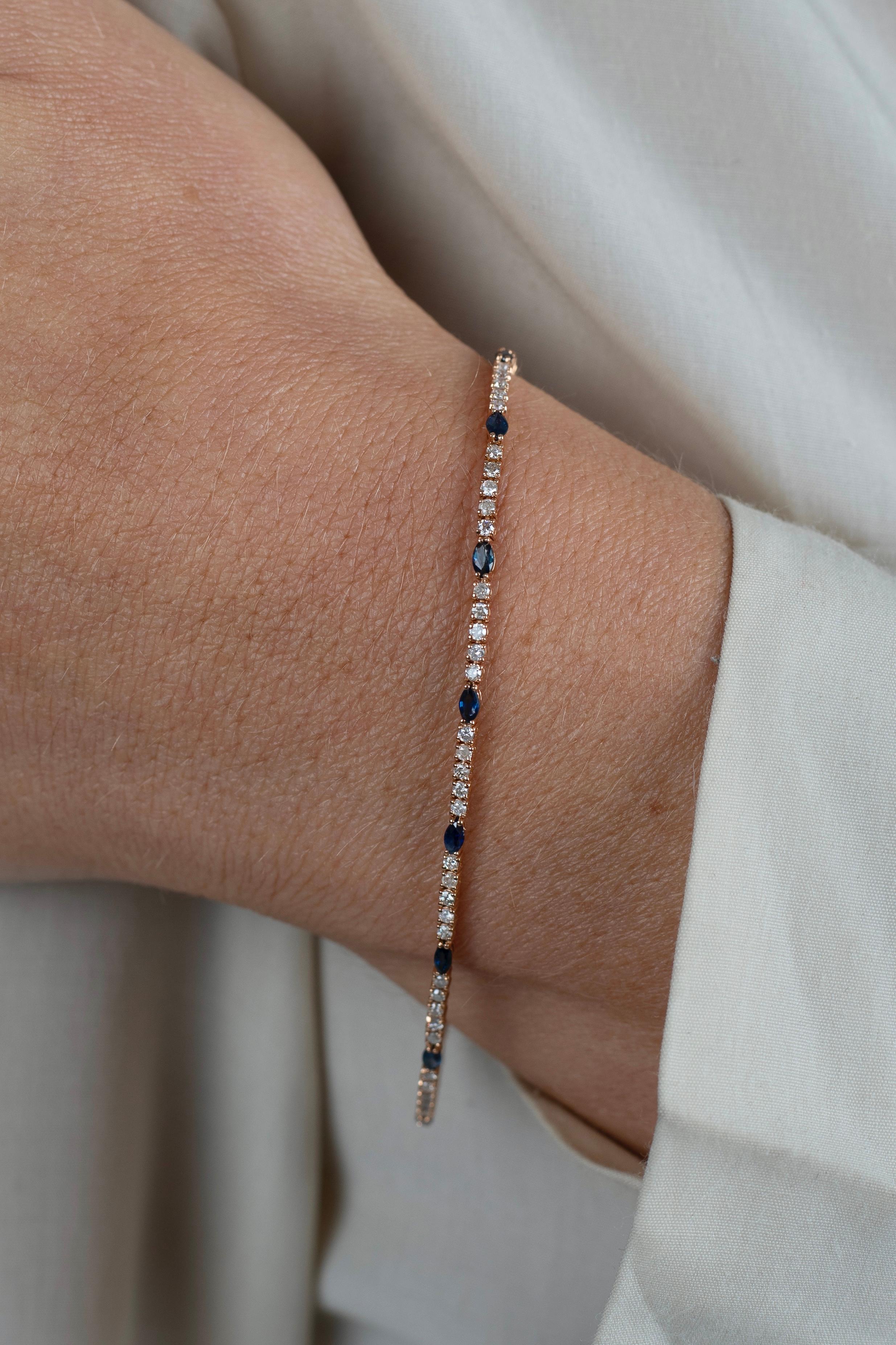 Discover the unique charm of this elegant tennis bracelet, featuring a combination of natural round-cut diamonds and marquise-cut blue sapphires. Set in 18 karat rose gold, this piece offers a refreshing take on the classic diamond tennis bracelet.