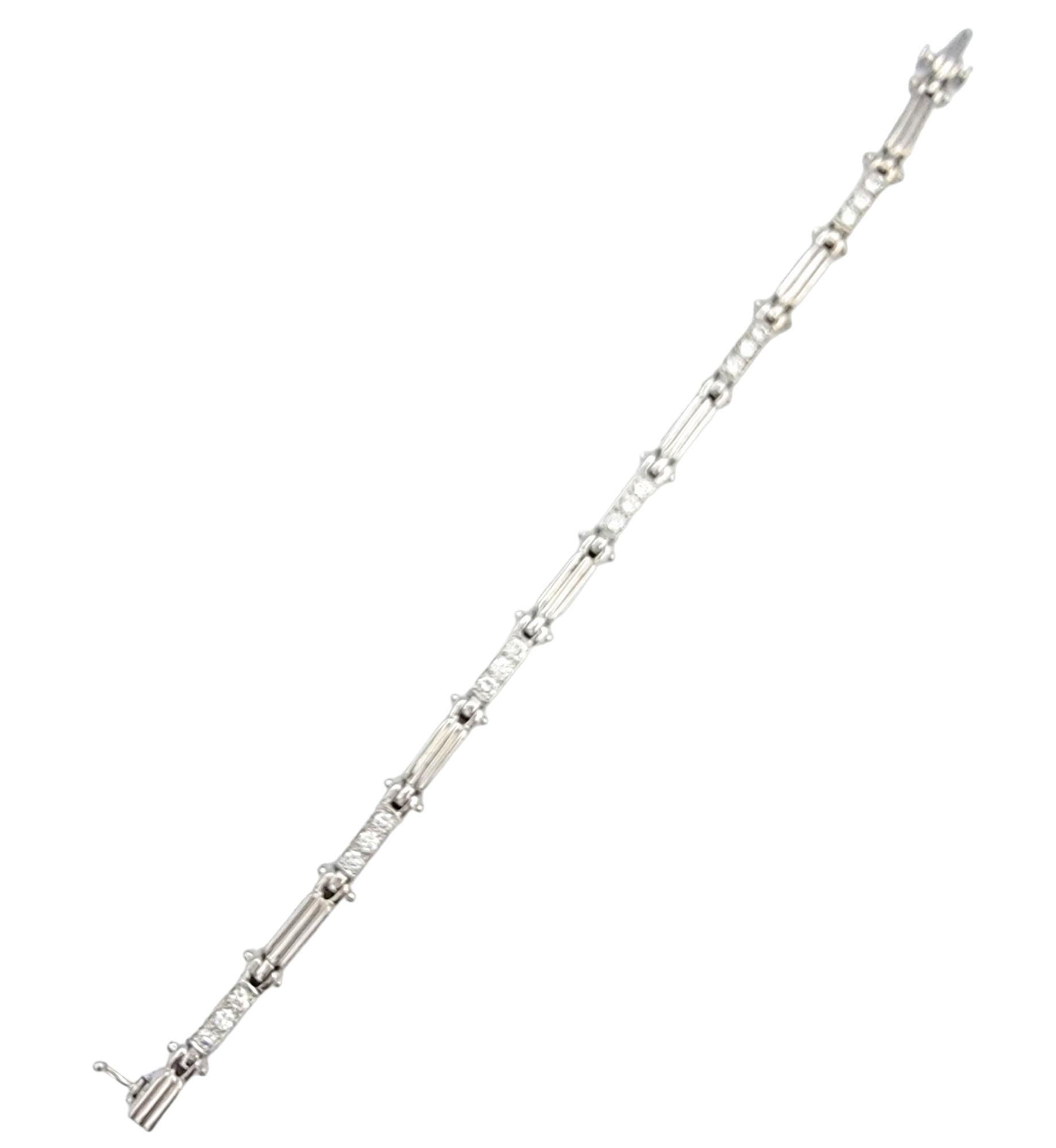 This exquisite 14 karat white gold link bracelet is a true testament to elegance and sophistication. Its alternating link design, with three dazzling round diamonds set on one link and a beautifully ridged pattern on the next, creates a captivating