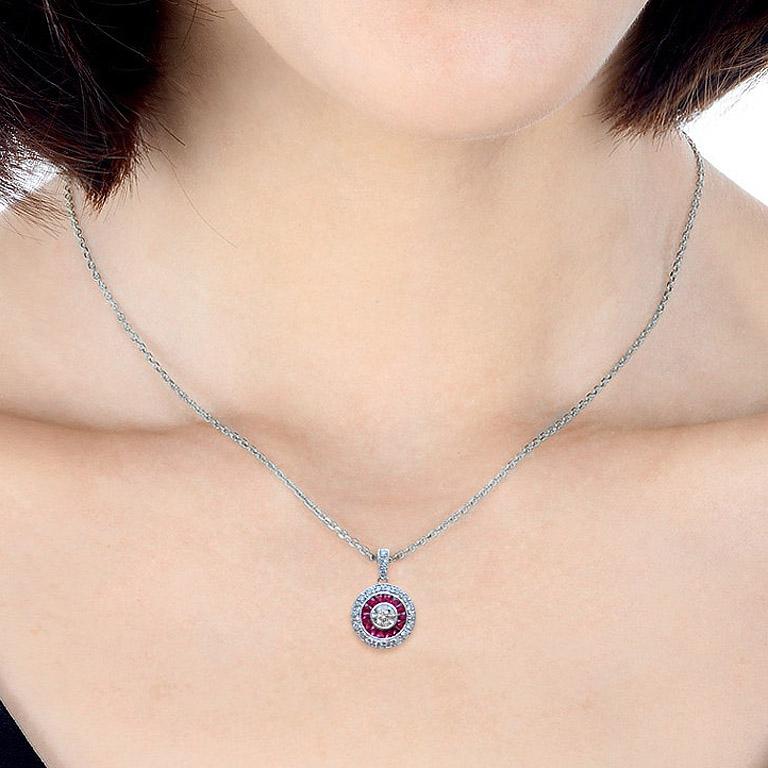 This Art-Deco style pendant is completely spectacular! The vibrant color stone (you can select Blue Sapphire, Emerald, Ruby) is a specialty cut to surround the excellent round brilliant cut center diamond, which is in a thin bezel with millgrain