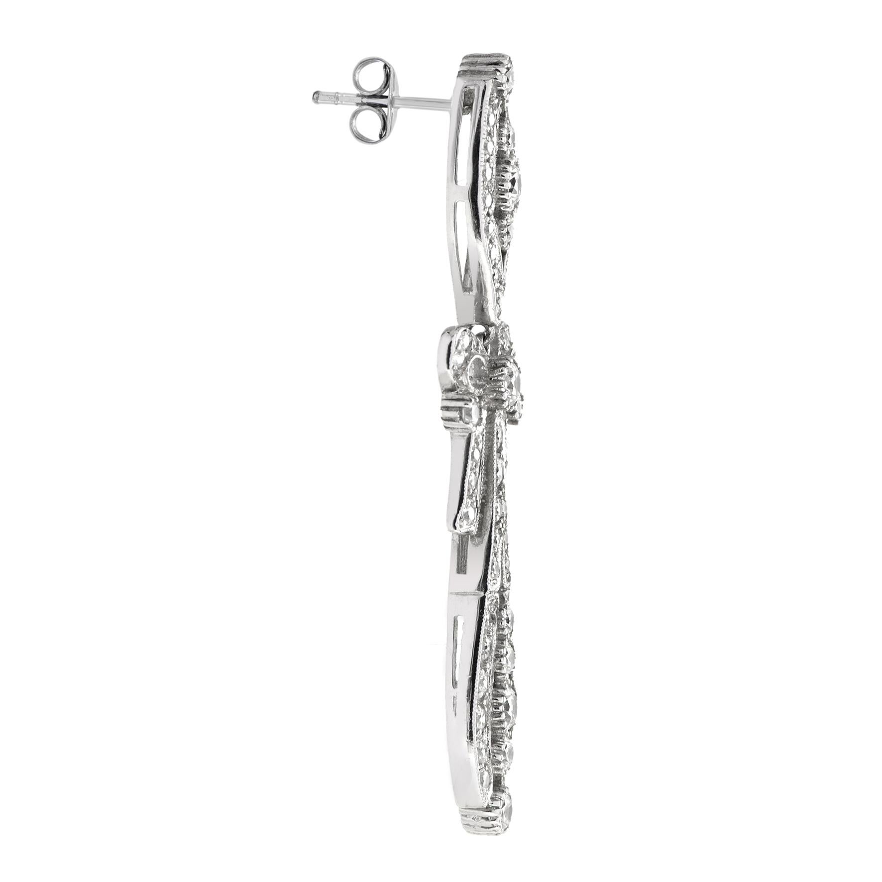 Stunning Art Deco style dangle earrings in 18k white gold featuring 60 sparkling diamonds worked info a feminine bow and foliage design.
Information
Width: 12 mm.
Length: 52 mm.
Weight: 15.07 g. (approx. total weight)
Backing: Push