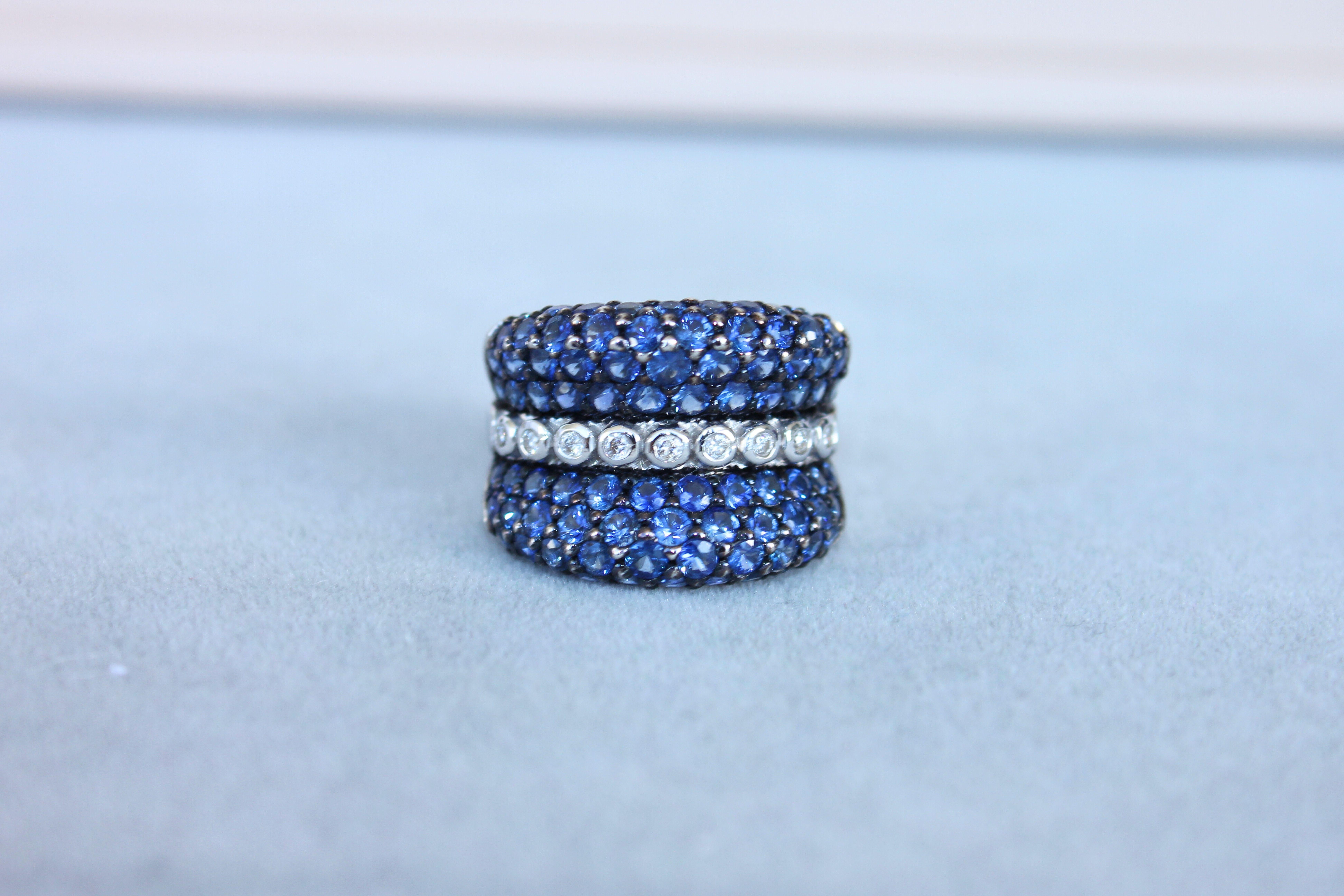 Modern Round Diamond Bezel Set Blue Sapphire Pave Set 18 Karat White Gold Unique Ring For Sale