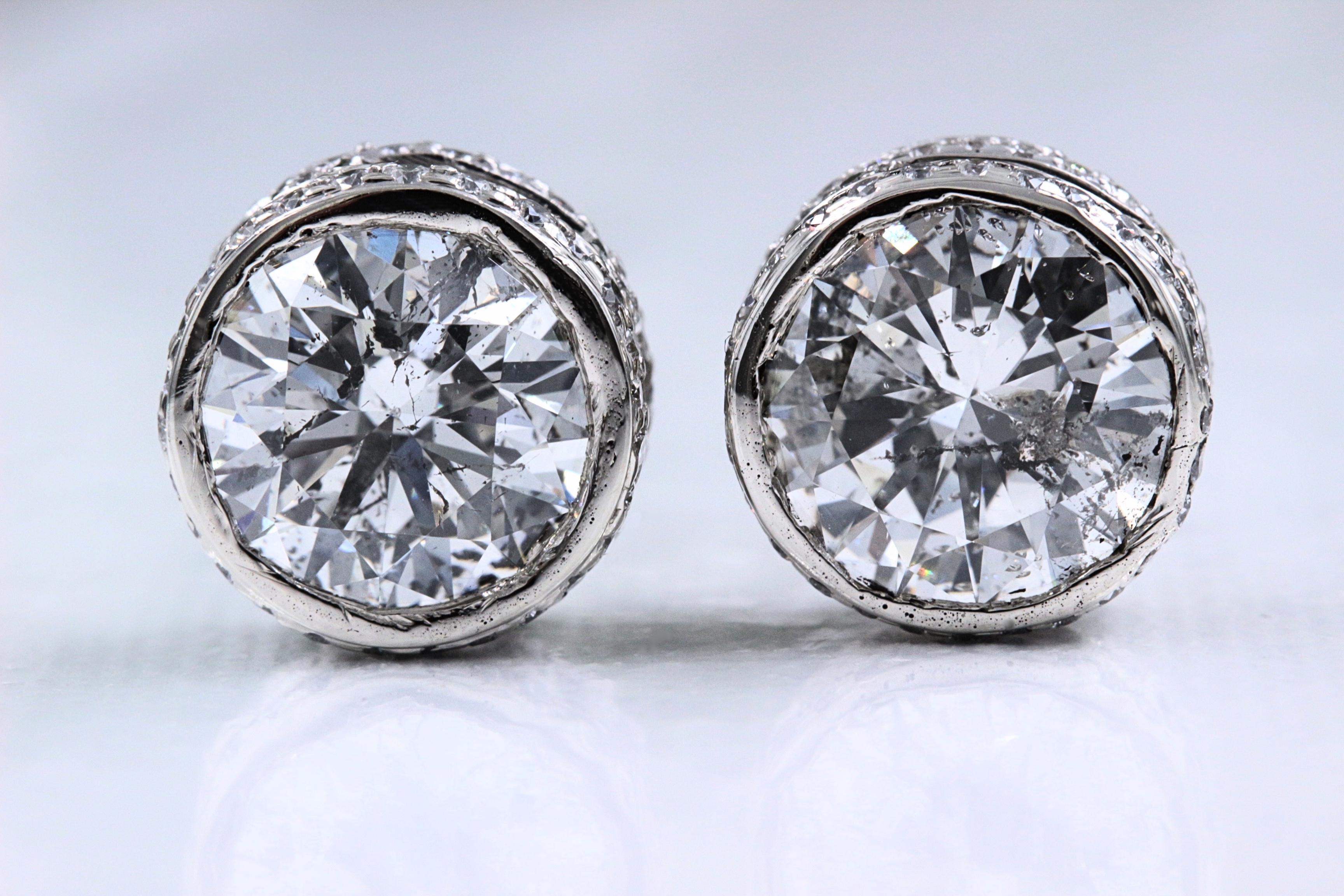 Round Diamond Solitaire Stud Bezel Set Earrings

Metal:  14k White Gold
Width:  10.3 MM Width - 6.08 MM Height
Total Carat Weight:  5.87 tcw
Diamond #1:  Round 2.31 cts I color, I1 clarity  
Diamond #2:  Round 2.38 cts I color, I1 clarity
Accent
