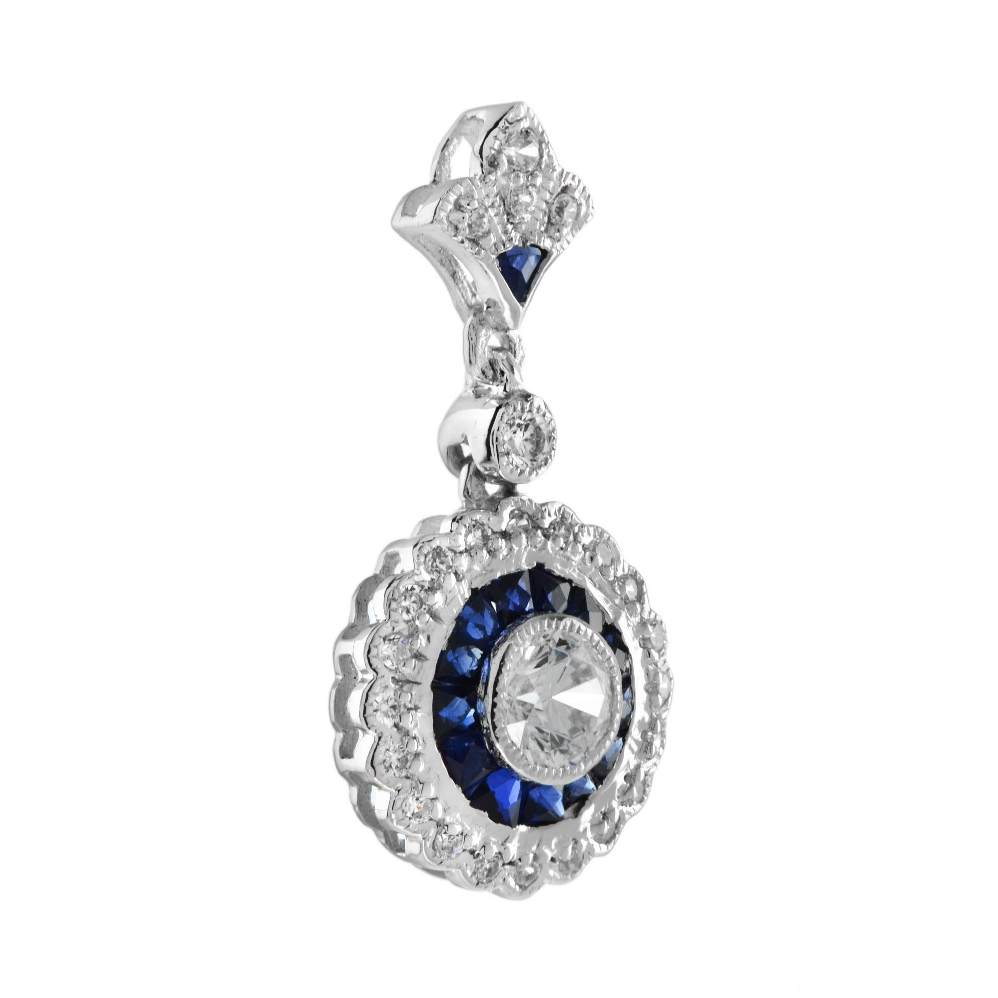 An Art Deco style diamond and sapphire pendant. The center diamond is a 0.25 Carat round cut of exceptional brightness. It is surrounded by custom but sapphire that are cut by hand to fit seamlessly together. The sapphires are further enhanced by a