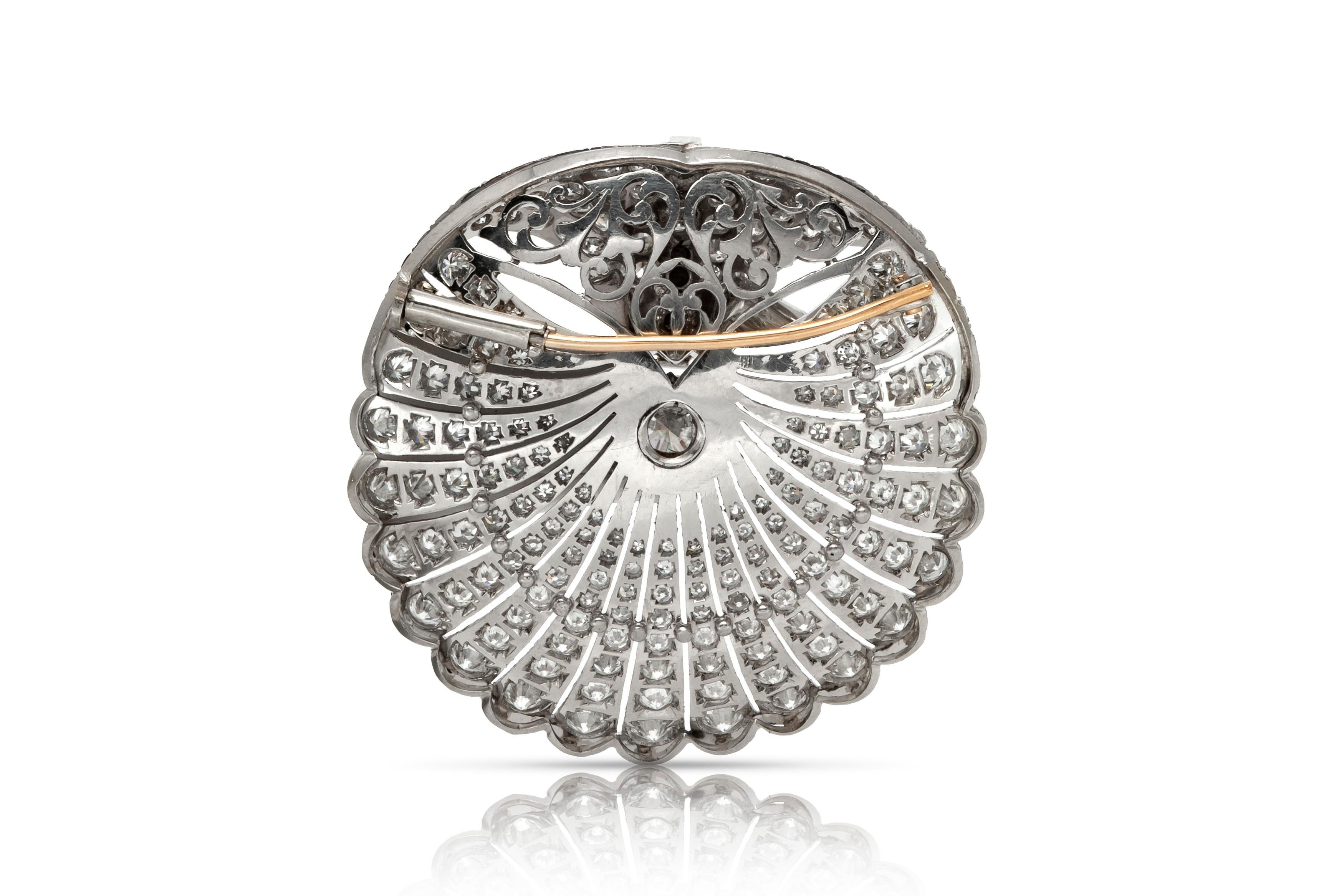 Finely crafted in plainum with a center round cut diamond weighing 1.48 carats.
The brooch features round cut diamonds weighing a total of approximately 20.00 carats.