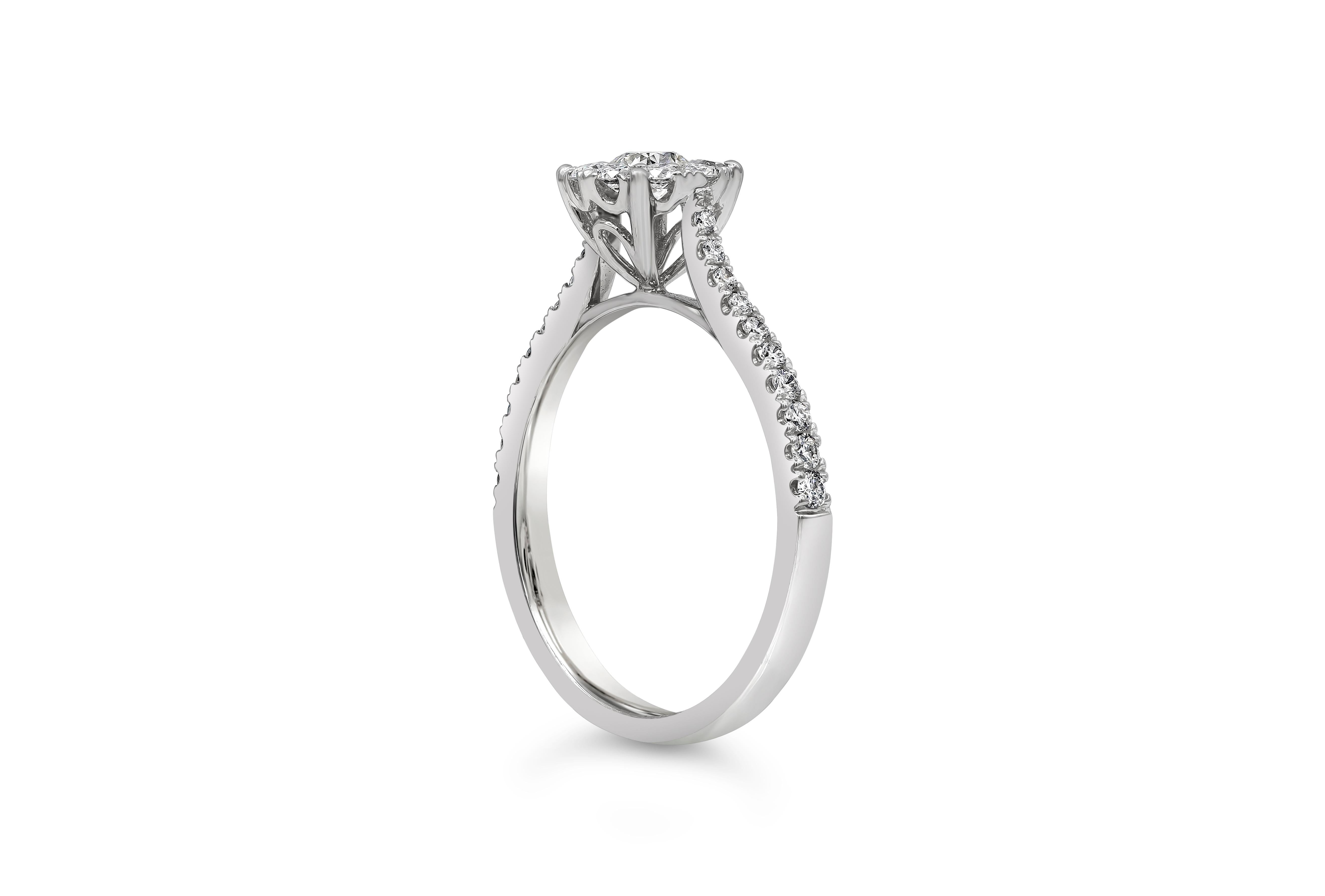 A classy and attractive halo engagement ring features a 0.19 carats round cut diamond surrounded by a single row of round diamonds. The shank of the ring also set with round diamonds. Diamonds weigh 0.39 carats total. Set in 18k white gold.

Style
