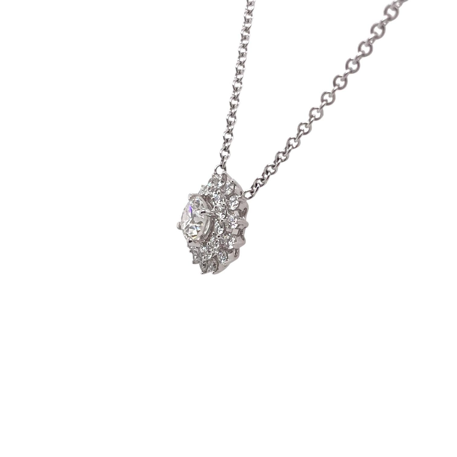 Diamond cluster pendant in 14k white gold contains 1 center round brilliant diamond, 0.70ct and round brilliant diamonds surrounding, 0.62tcw. Center diamond is H in color and VS2 in clarity. Side diamonds are near colorless and VS in clarity,