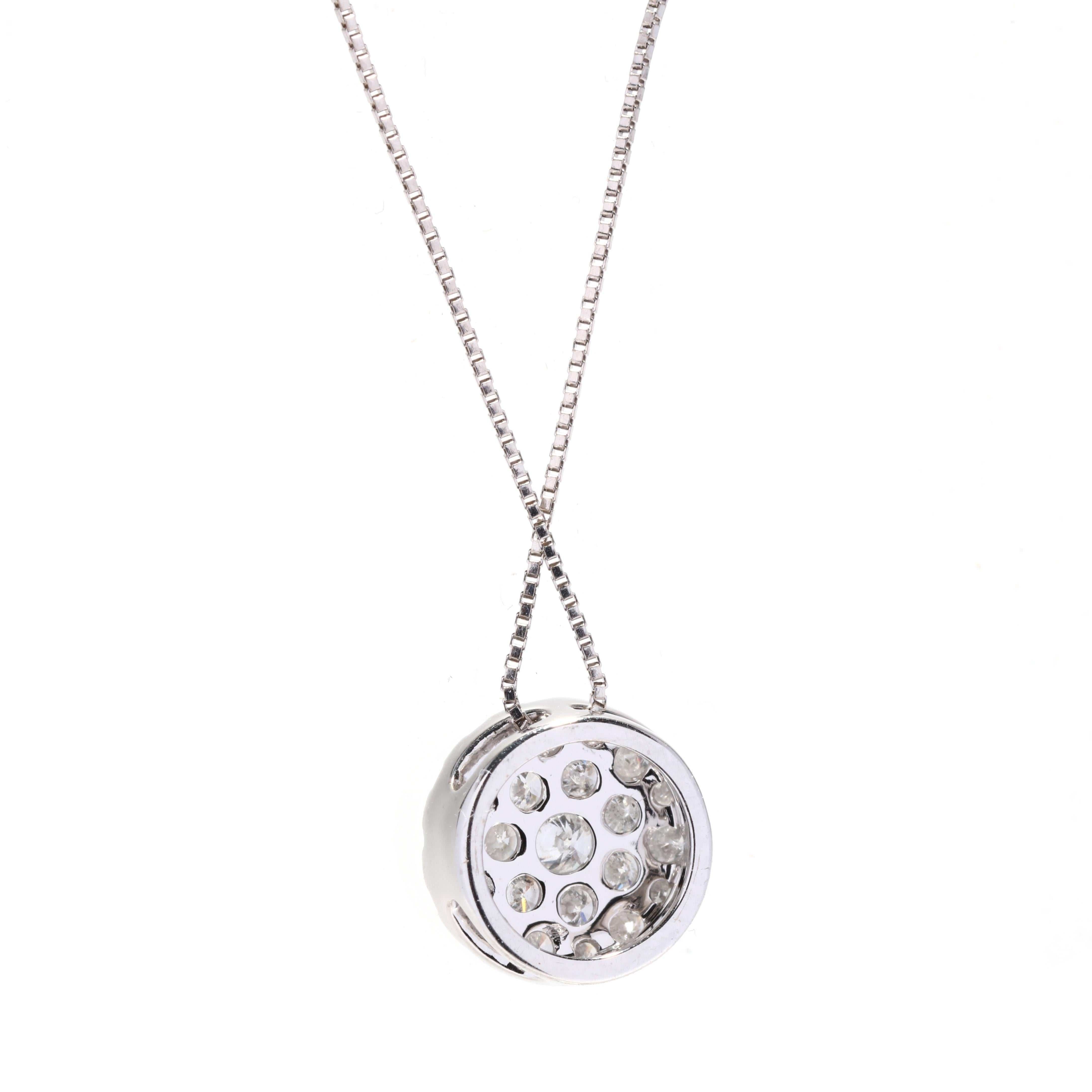 A 10 karat white gold round diamond cluster pendant necklace. This simple diamond pendant features a round design with pavé set round brilliant cut diamonds weighing approximately .40 total carats and suspended from a thin box chain.

Stones: 
-