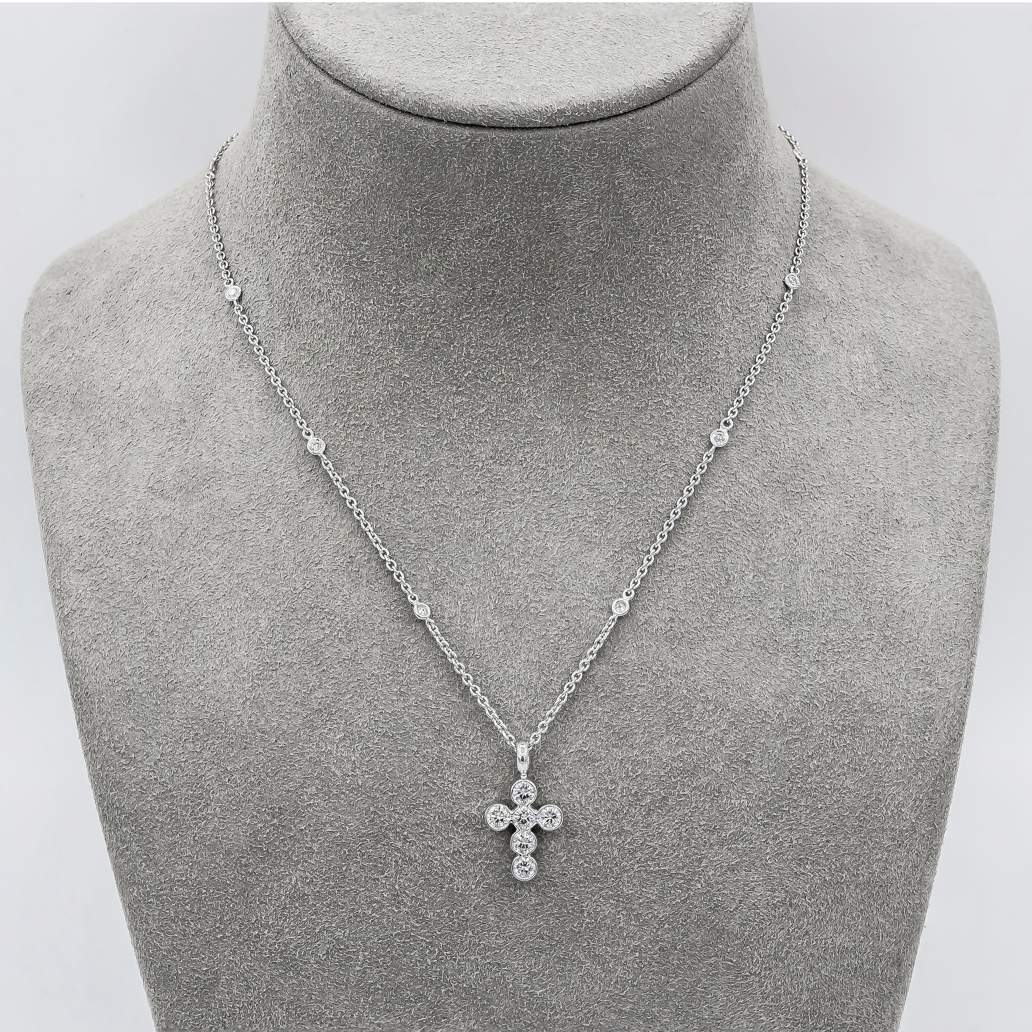 A brilliant pendant necklace showcasing six round diamonds bezel set in an 18 karat white gold cross design. Suspended on a diamond by the yard chain. Diamonds weigh 1.27 carats total.

Style available in different price ranges. Prices are based on