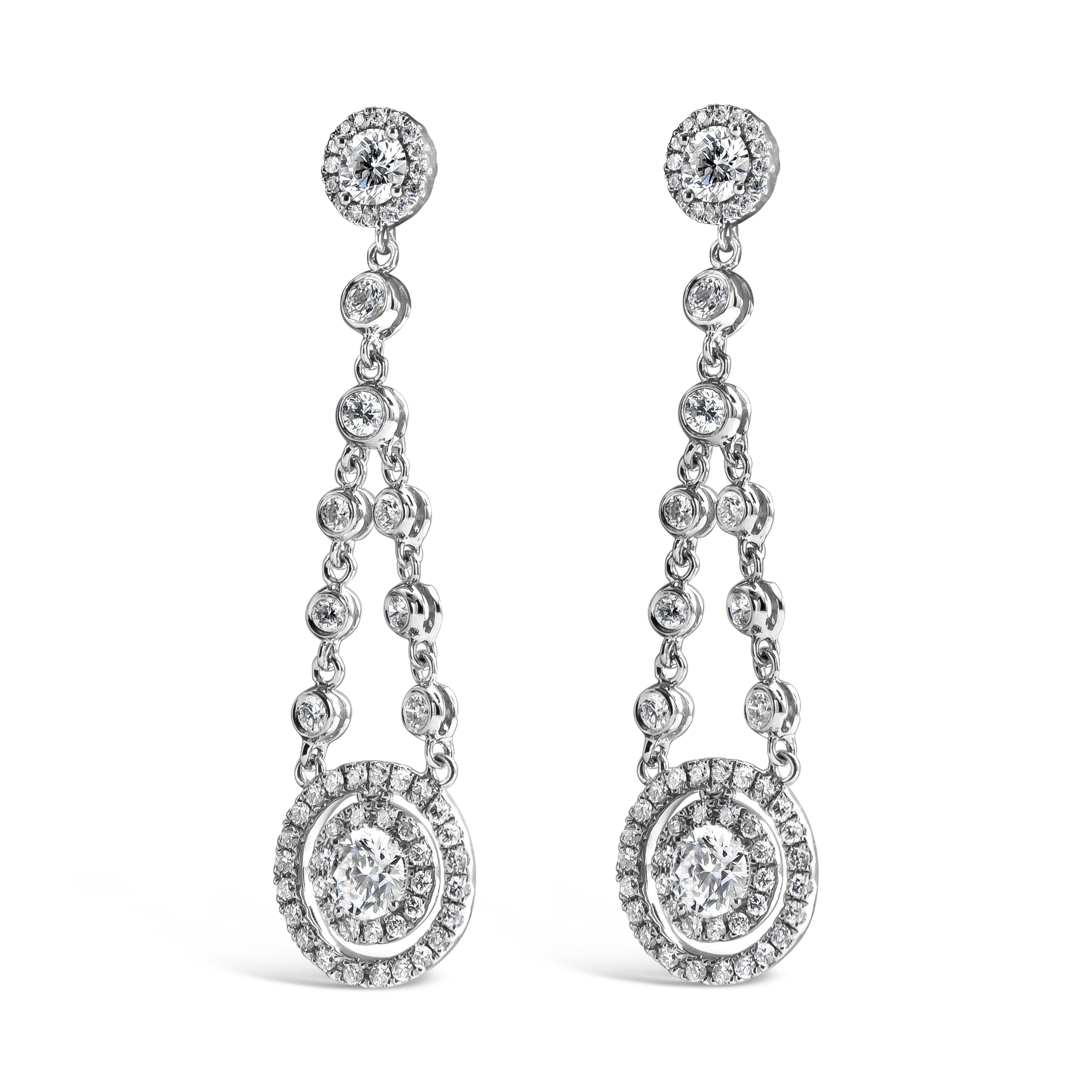 A simple pair of dangle earrings showcasing a round diamond halo dangling from a diamond by the yard chain. Attached to a diamond encrusted post. Diamonds weigh 1.75 carats total. Made in 18 karat white gold.

Style available in different price