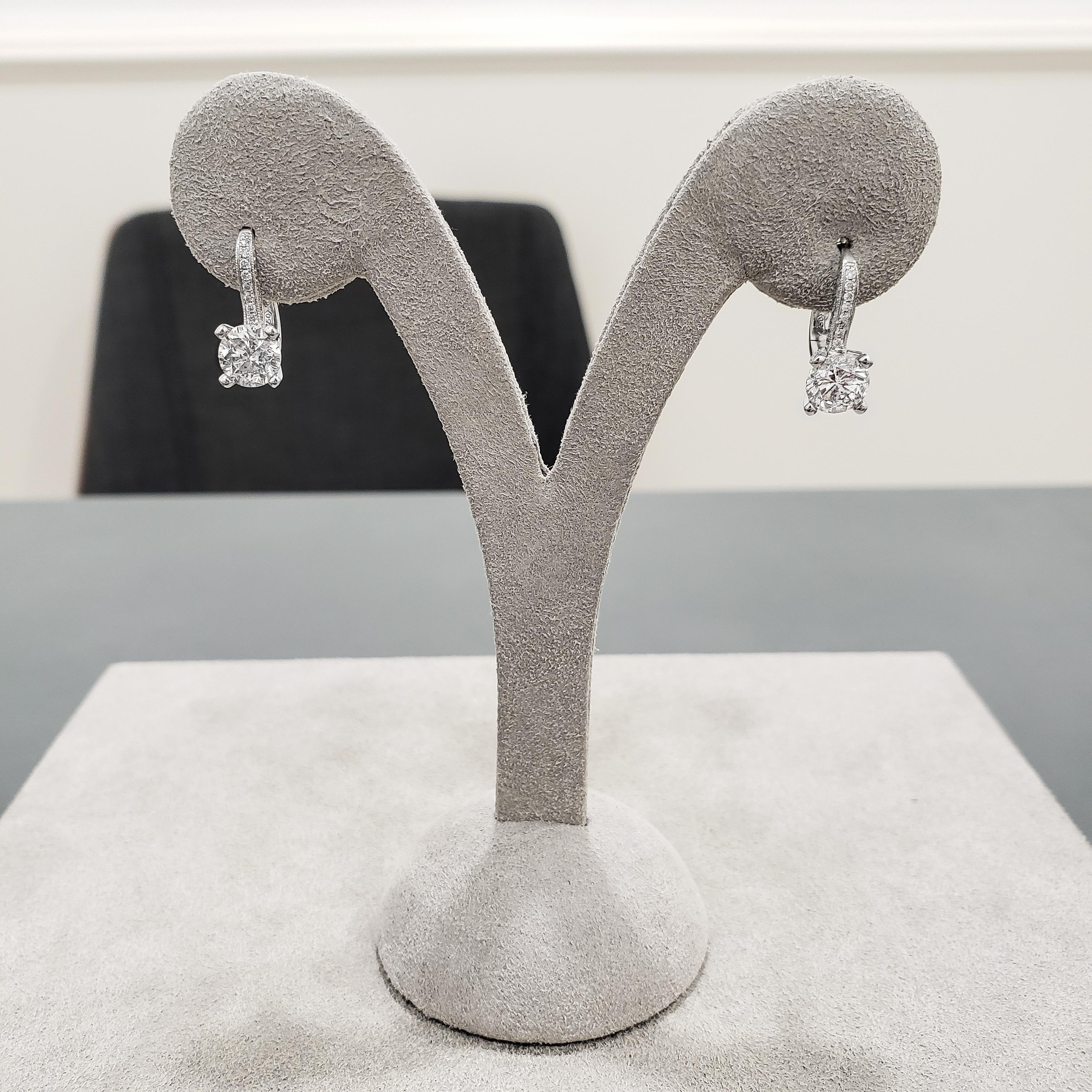 A simple pair of dangle earrings featuring two round brilliant diamonds, each set in an 18k white gold lever-back accented with diamonds. Center diamonds weigh 2.08 carats total; accent diamonds weigh 0.31 carats total.

Roman Malakov is a custom