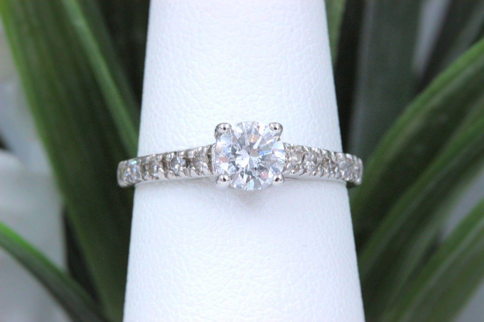 Diamond Engagement Ring 
Style:  Solitaire with Diamond Band
Metal:   14k White Gold
Size:  6- sizable
Total Carat Weight:  0.64 TCW
Center Diamond Shape:   Round Diamond 0.50 Cts
Diamond Color & Clarity:  J - SI3
Accent Diamonds:  10 Round Diamond