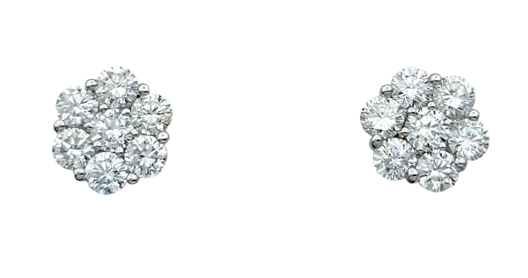 Indulge in the timeless elegance of these exquisite floral motif stud earrings, designed to captivate with their brilliant sparkle. Crafted in luxurious 19 karat white gold, each earring is adorned with a stunning cluster of round diamonds,