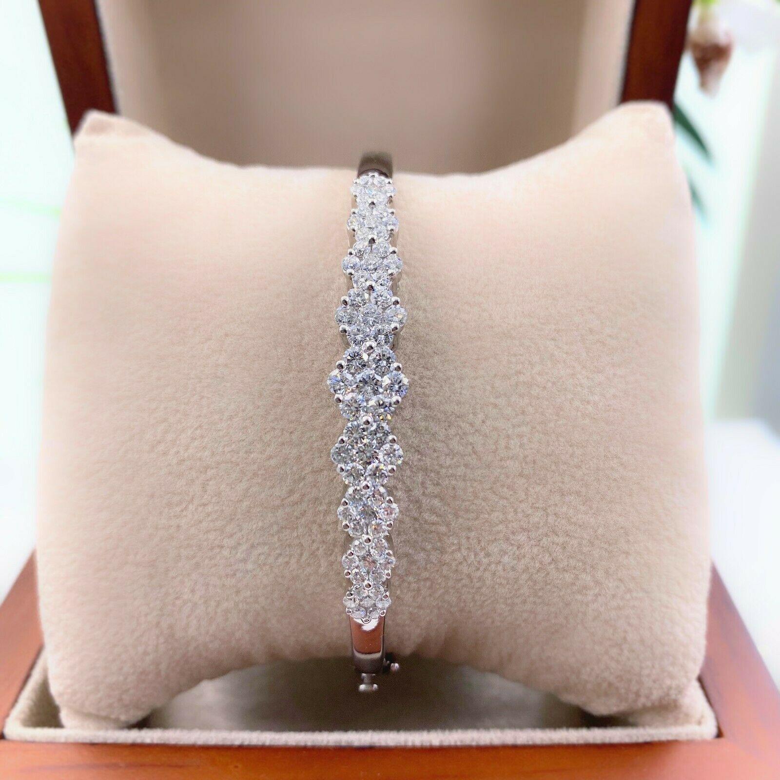 Diamond Flower Design Bangle Bracelet

Style:  Bangle

Metal:  14kt White Gold

Size / Measurements:  6.5'

TCW:  2.00 tcw

Main Diamond:  63 Round Brilliant Diamonds 

Color & Clarity:  F - G / SI1 - SI2

Hallmark:  14 kt

Includes:  Certified