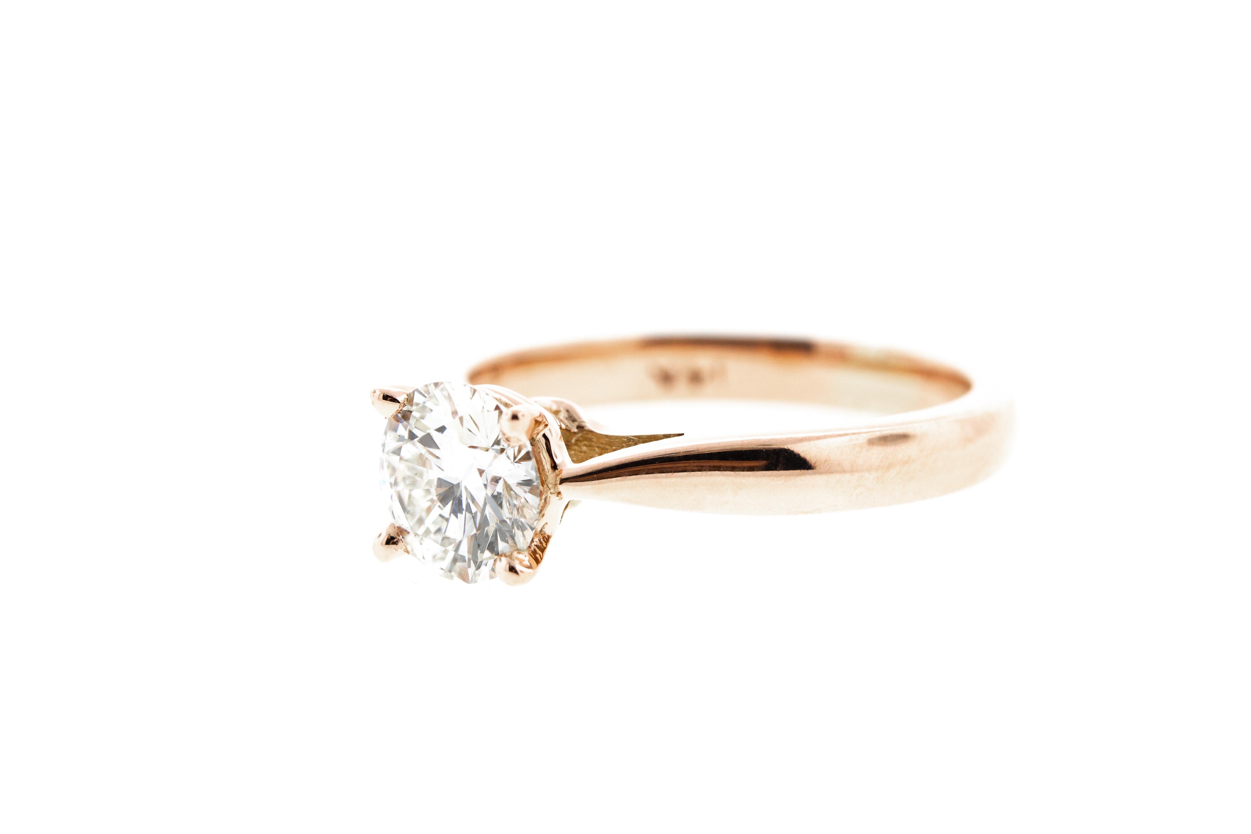 This rose gold diamond engagement ring features a custom built-in setting with a tapered shank. This ring can be made in any color gold for any shape of diamond and features a round GIA certified diamond.