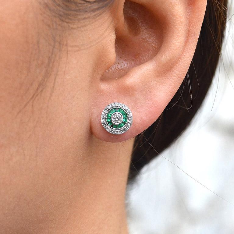 These Art-Deco stud earrings are completely spectacular! The vibrant color stone (you can select Blue Sapphire, Emerald, Ruby) are specialty cut to surround the excellent round brilliant cut center diamond, which is in a thin bezel with mil-grain