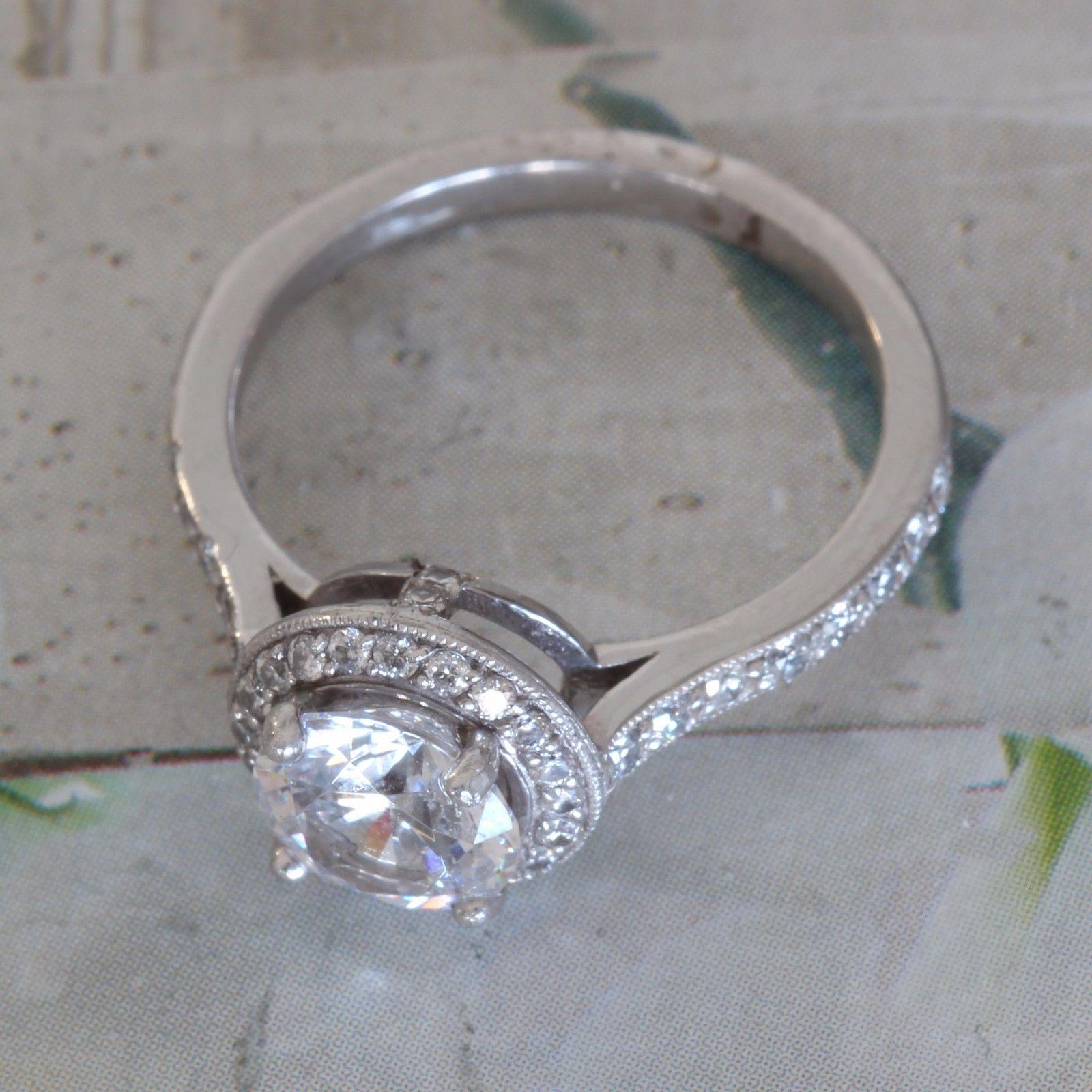 Round Diamond Halo Engagement Ring - 1.2 Center - 1.7 Carat Total
Ring May be made to order from scratch to accommodate your exact finger size 
or a different stone if the budget requires it, takes approximately 3-6 business weeks
Setting with no