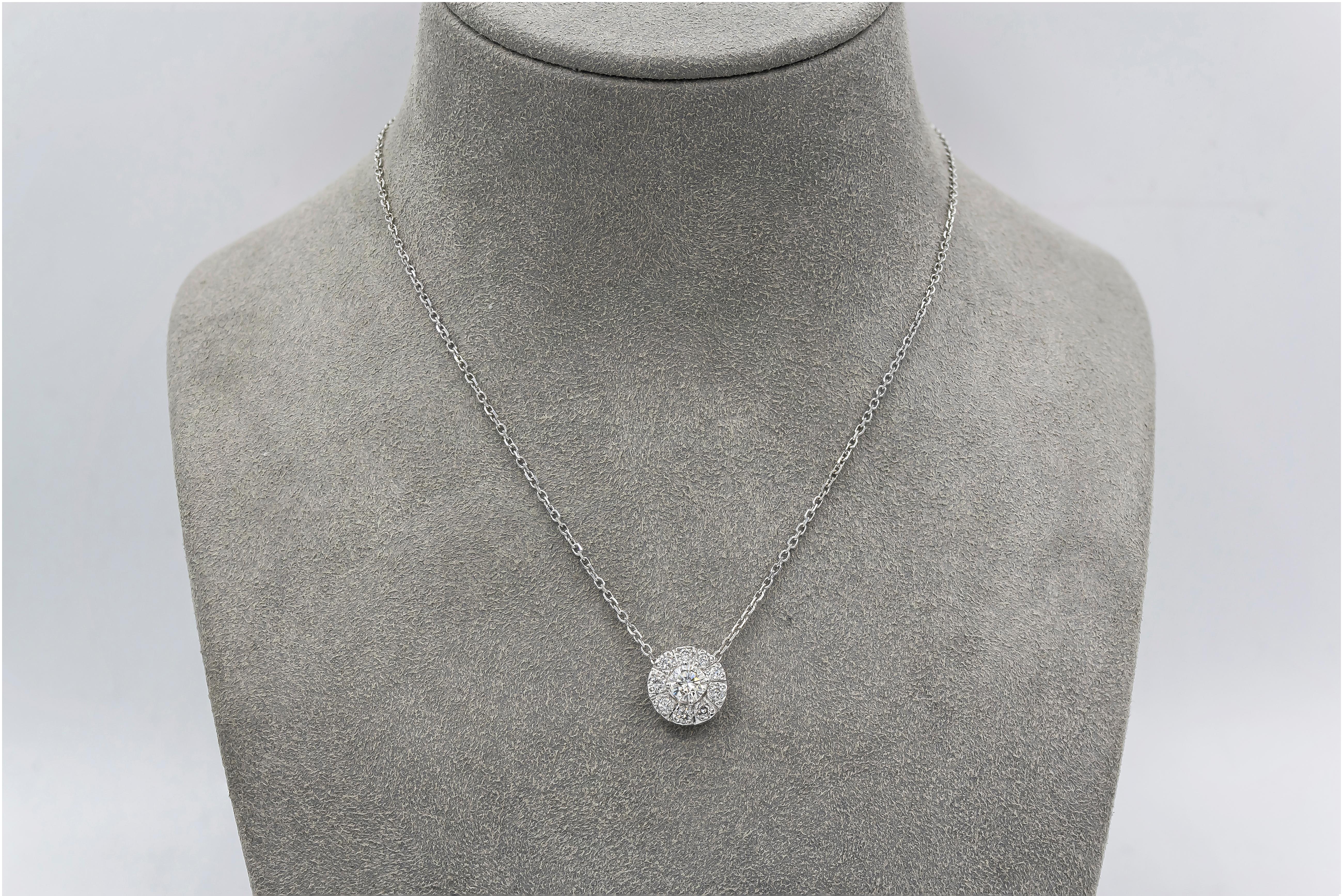 Showcases a brilliant round diamond weighing 0.53 carats, surrounded by a row of round diamonds weighing 0.27 carats total. Set in 14k white gold. Suspended on an 18 inch adjustable white gold chain.

Style available in different price ranges.