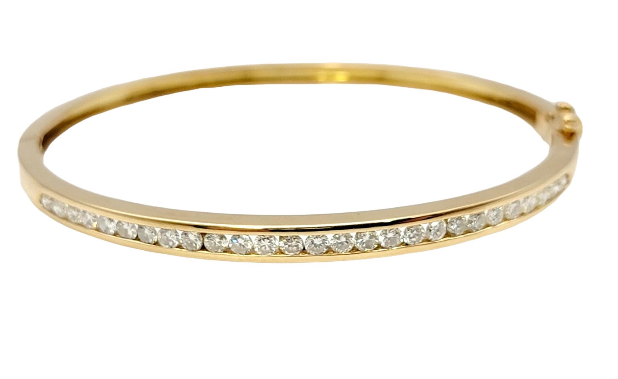 Sleek yellow gold bangle bracelet accented with a single elegant row of round channel set diamonds. The perfect bracelet for everyday wear!

* See last photo for coordinating stackable bracelets in additional gemstone options. Please see our other