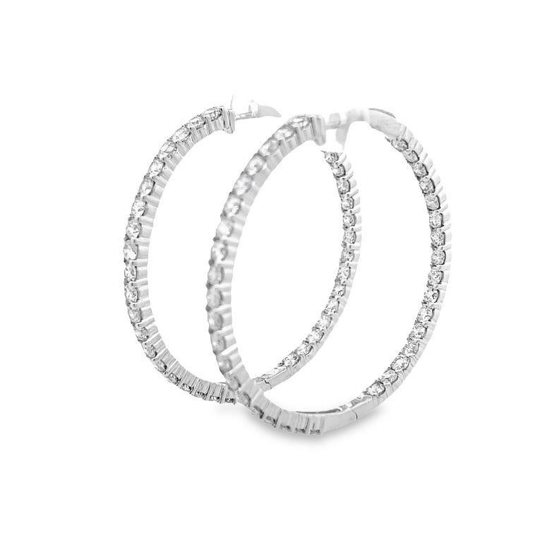 Discover exquisite earrings that boast an endless inside-out round hoop design, sparkling from every angle. Made with 52 round white diamonds, each stone measuring 0.10 points, these elegant hoop earrings weigh a total of 5.05CT and are set in