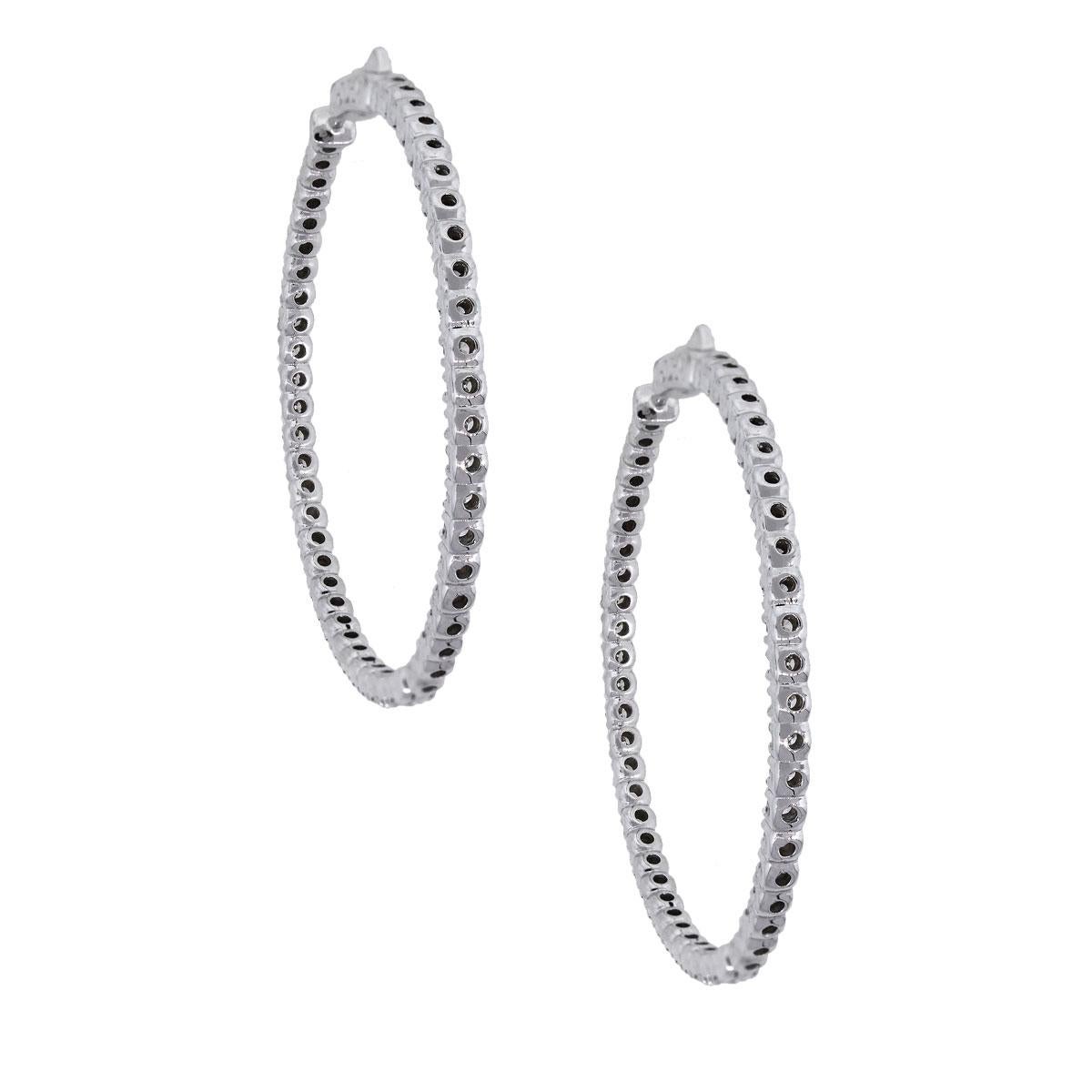 Material: 14k white Gold
Style: Diamond Inside Out Hoops
Diamond Details: Approximately 4.59ctw of round brilliant diamonds. Diamonds are G/H in color and SI in clarity.
Earring Measurements: 2″ x 0.11″ x 2″
Total Weight: 19.7g (12.6dwt)
Earring
