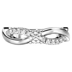 Round diamond moissanite spiral 14k gold ring.