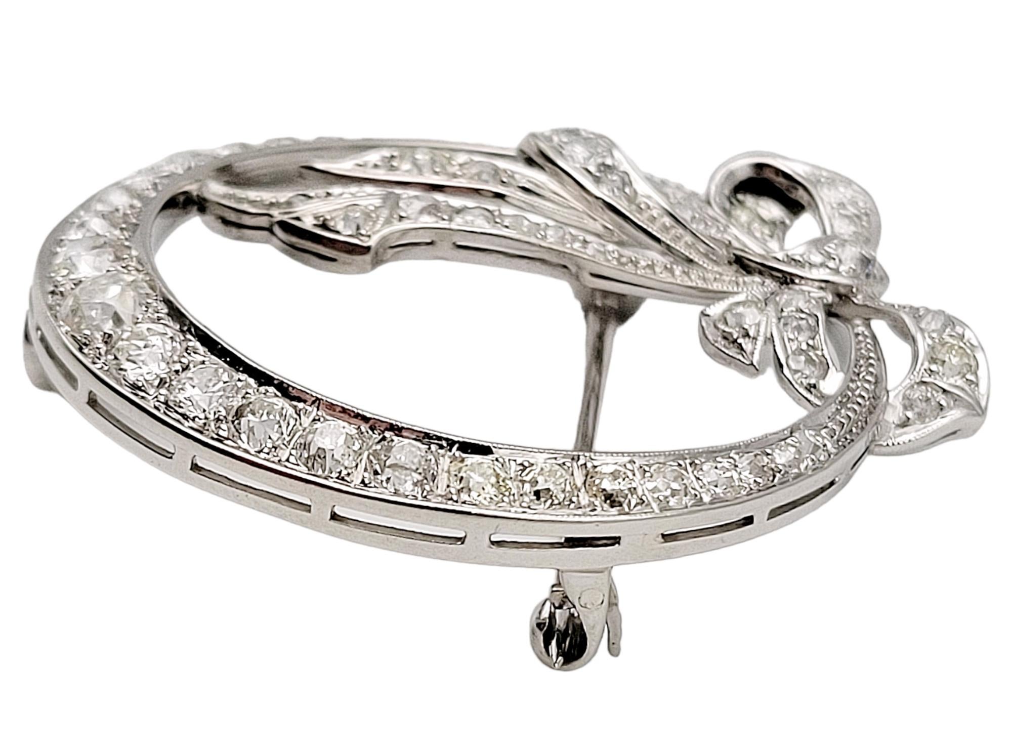 Round Cut Round Diamond Open Circle Brooch with Bow Detail in Polished Platinum