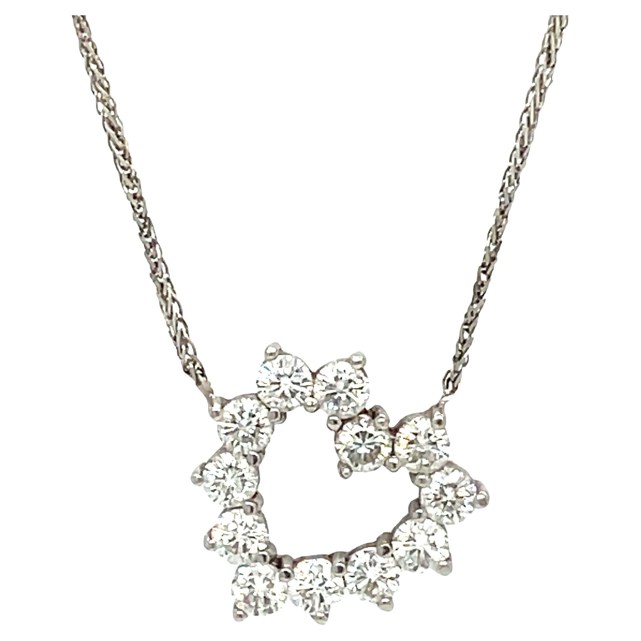 Love at first sight. This eye catching diamond heart pendant necklace is a sparkling symbol of love. The necklace showcases bright and beautiful round diamonds that will make her heart skip a beat. 

Crafted in 14K white gold, this romantic pendant