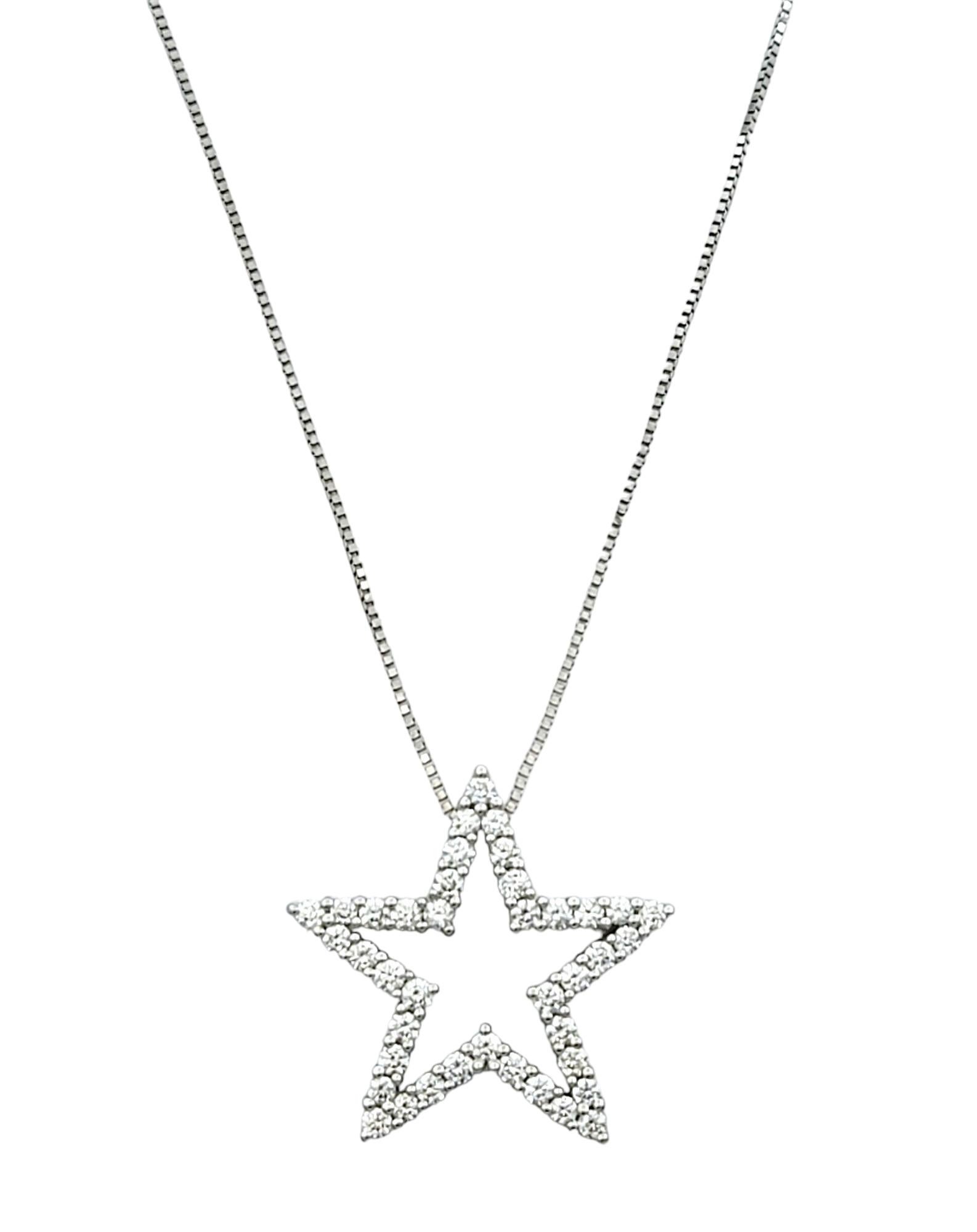 This stunning necklace features an open star design crafted from luminous 14 karat white gold, creating a celestial-inspired motif that exudes elegance and charm. The open outline of the star is adorned with sparkling diamonds, radiating brilliance