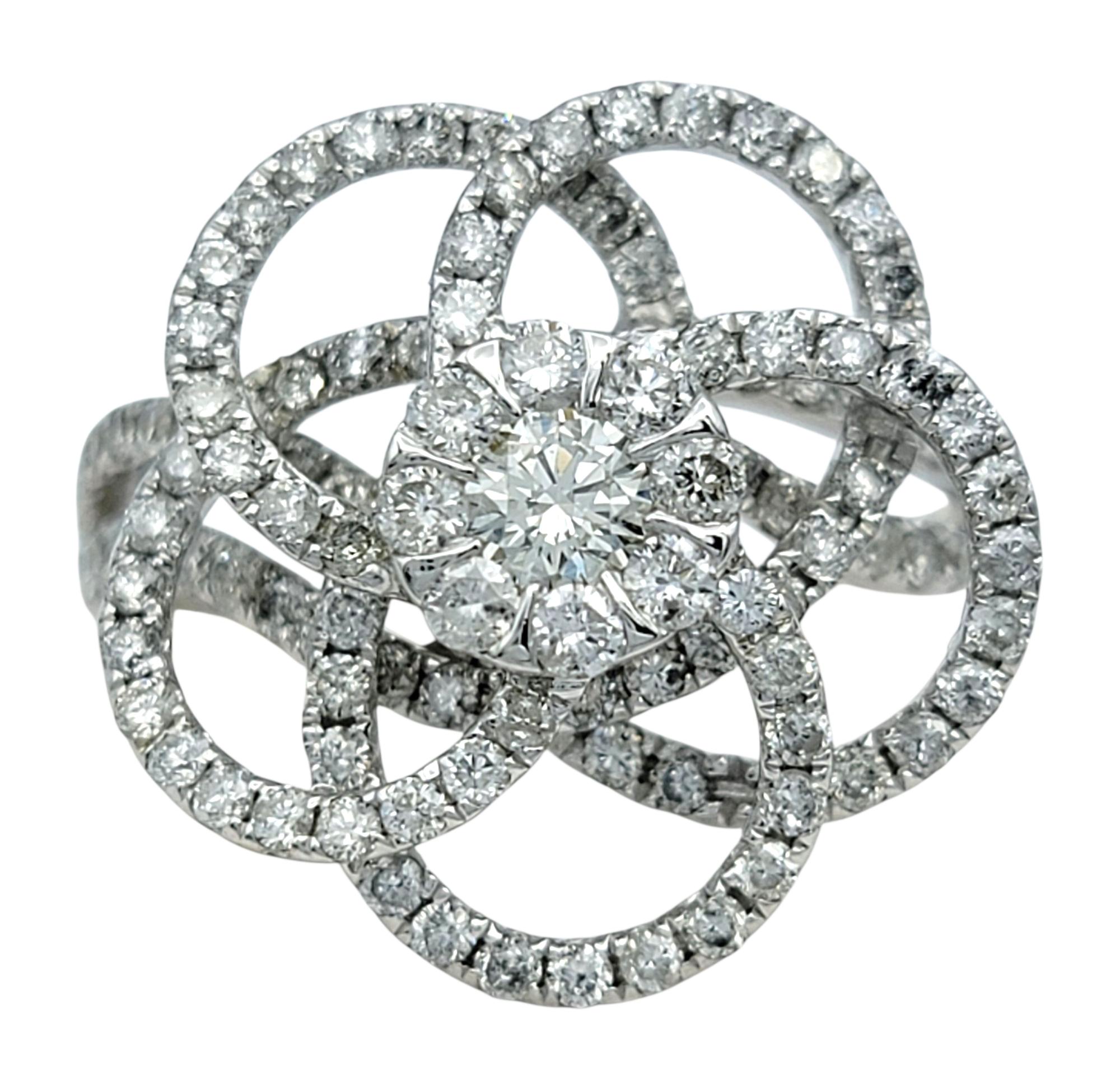 Ring Size: 7

An elegant fusion of artistry and sparkle, this custom diamond ring showcases an intricate flower design adorned with round brilliant cut diamonds. Featuring an intricate looping pattern which makes this piece both airy and bold. The