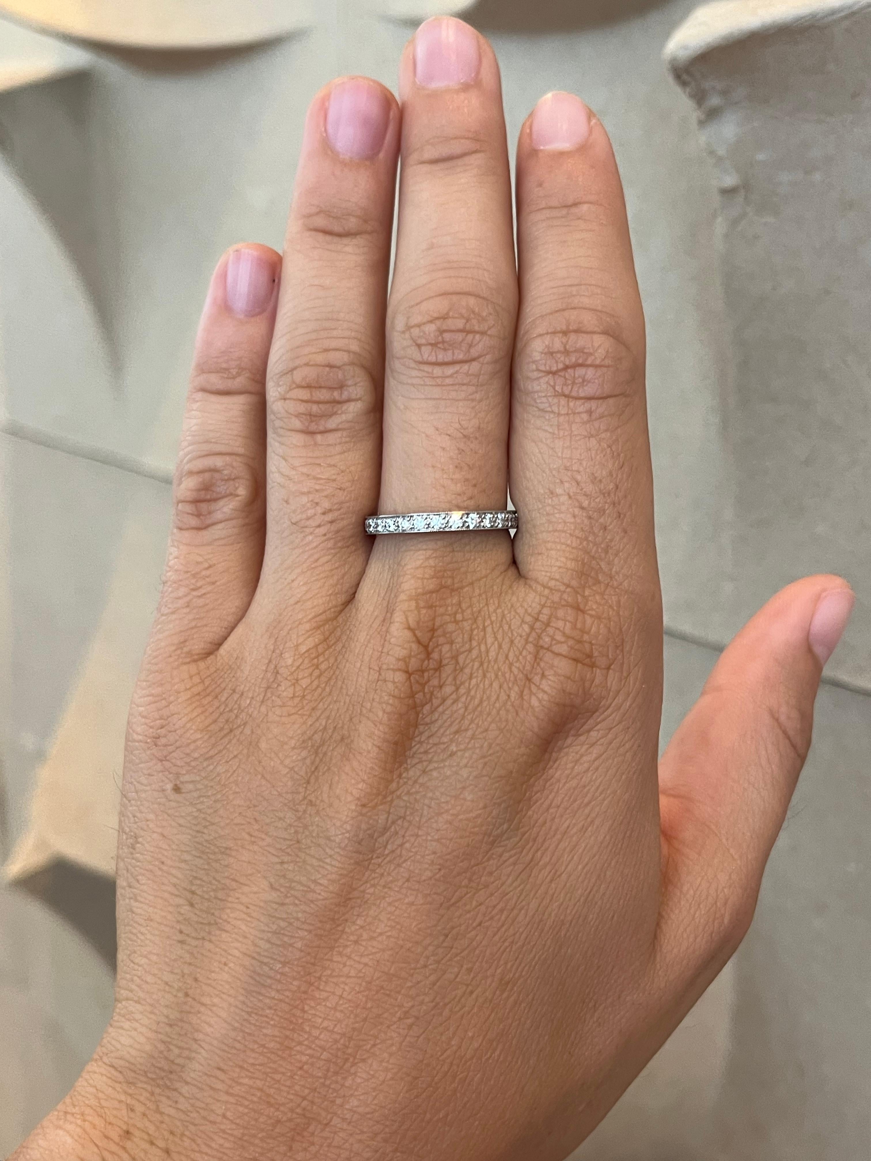 Crafted by Bracken Jewelers in Santa Monica, California. Platinum eternity wedding band studded with 28 bead-set round brilliant cut diamonds, featuring milgrain detailing and high polished sides.

- 28 round brilliant cut natural diamonds total