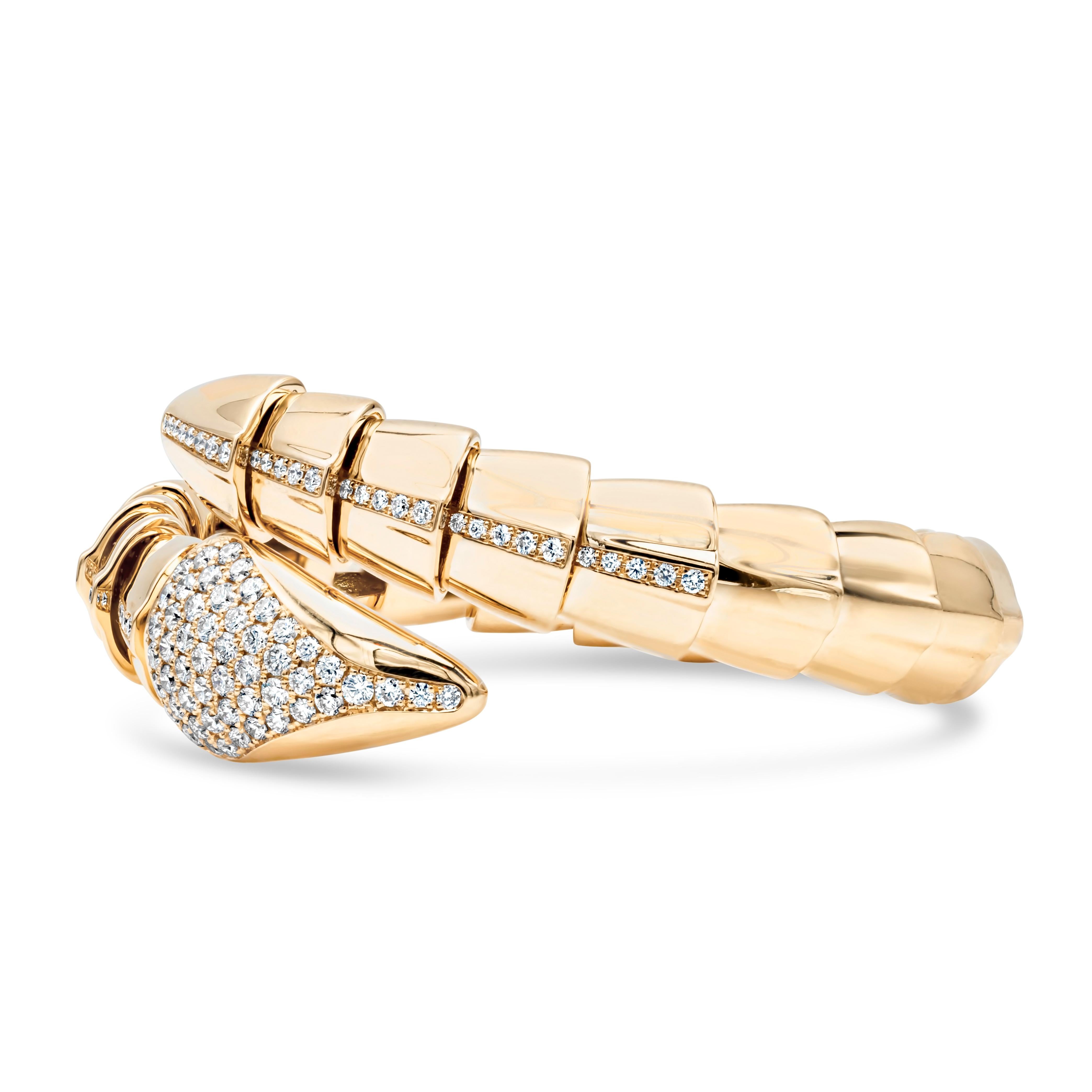 An artistic and high-quality bangle bracelet, featuring a serpentine motif made with 18K yellow gold. Beautifully accented with 100 round brilliant cut diamonds weighing 1.74 carats total with F color and VS-SI clarity. Perfect jewelry to accompany