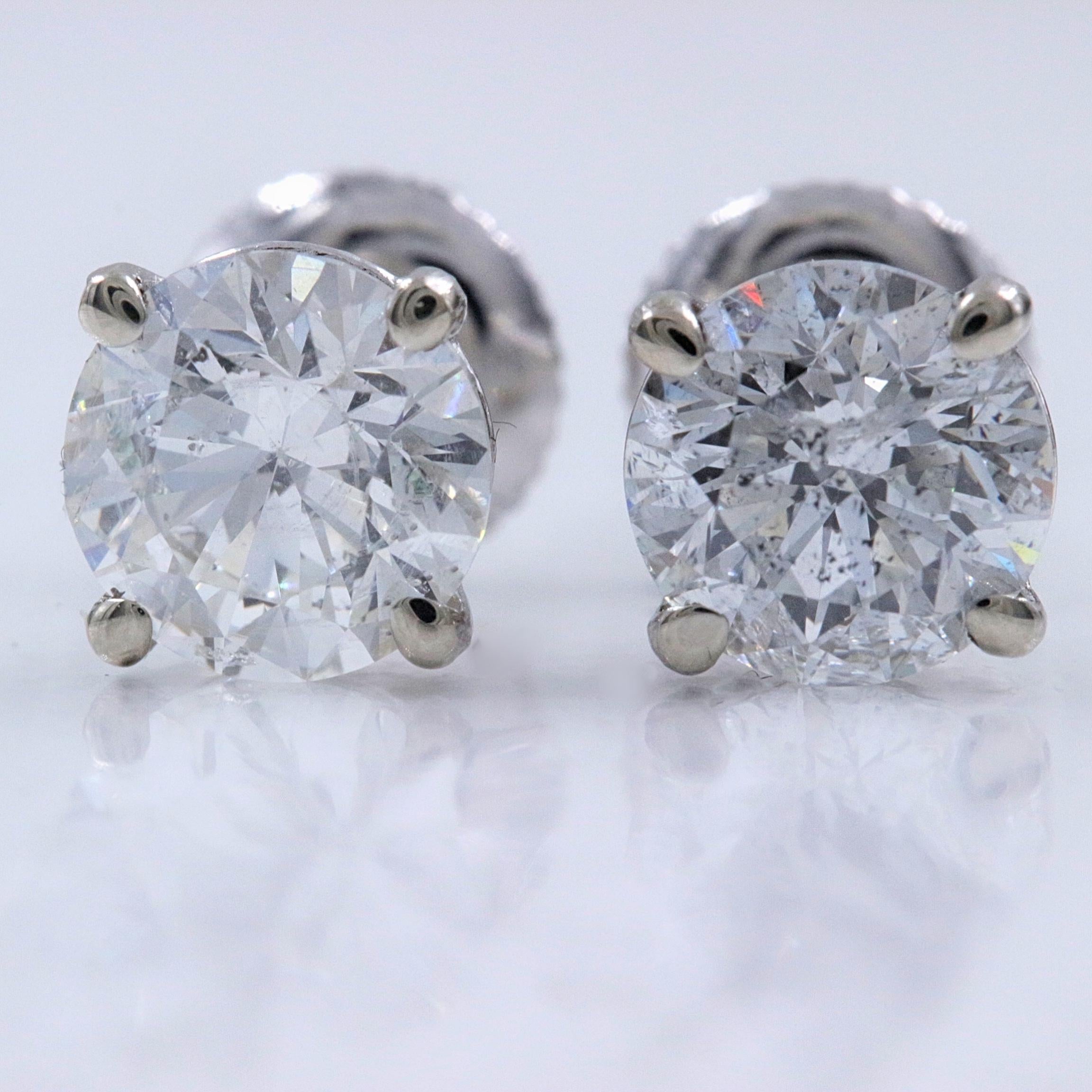 Round Diamond Solitaire Stud Earrings

Style:  Solitaire in 4-Prong Martini Setting with Screw Backs
Metal:  14k White Gold
Total Carat Weight:  2.00 tcw
Diamond #1:  Round 1.00 cts J I1
Diamond #2:  Round 1.00 cts J I1
Hallmark:  585

Retail Value: