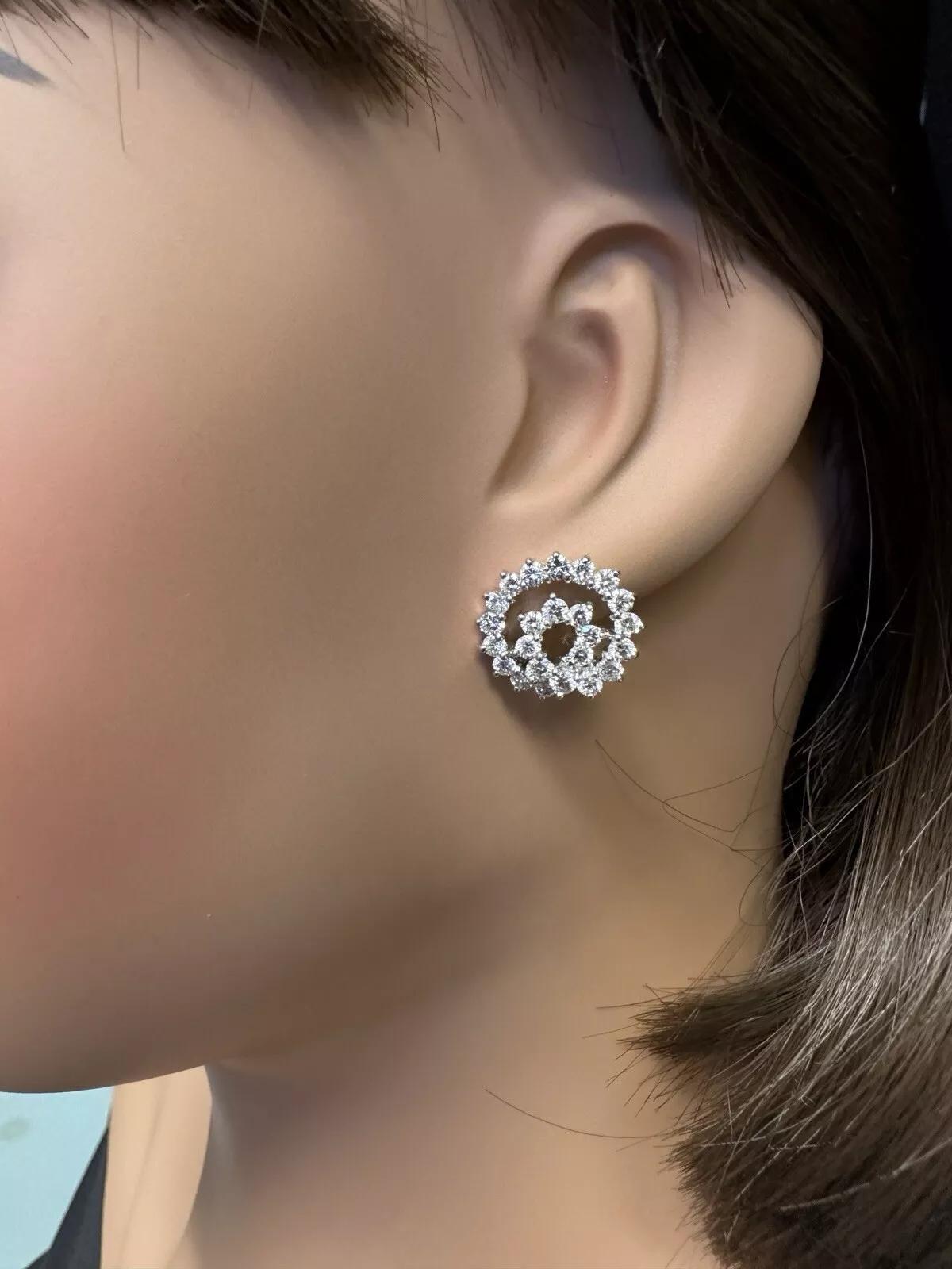 Round Diamond Swirl Button Earrings 2.50 cttw in 18k White Gold 

Diamond Earrings feature Round Brilliant Diamonds weighing 2.50 carats in total, prong set in a swirl design in 18k White Gold.

Earrings measure .65 inch across and .60 inch