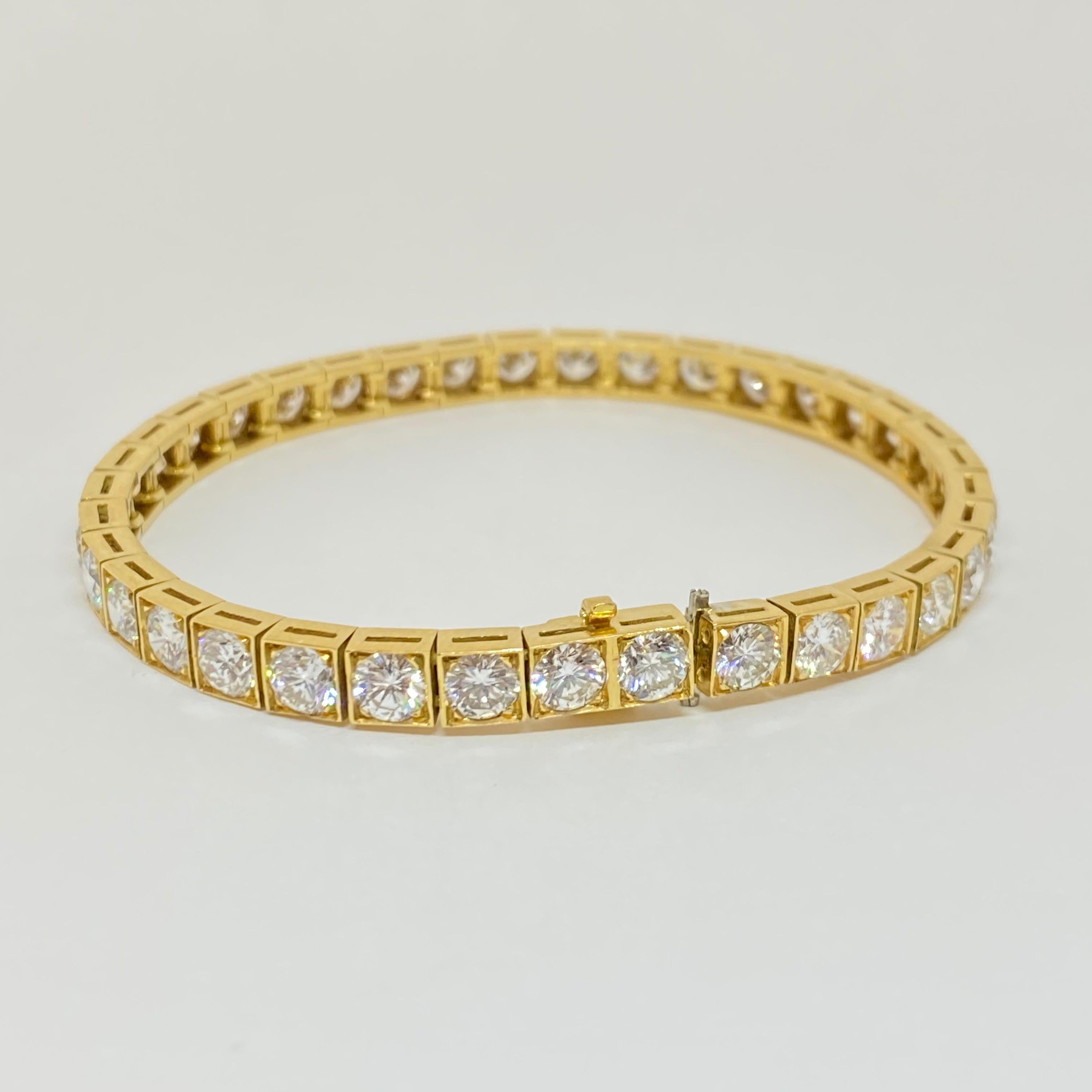 Elegant classic tennis bracelet in new condition designed in premium 18 karat yellow gold. Set with thirty-six round brilliant cut diamonds in square links, attached to a secure box and tongue clasp and safety.  The bracelet measures 5mm wide.