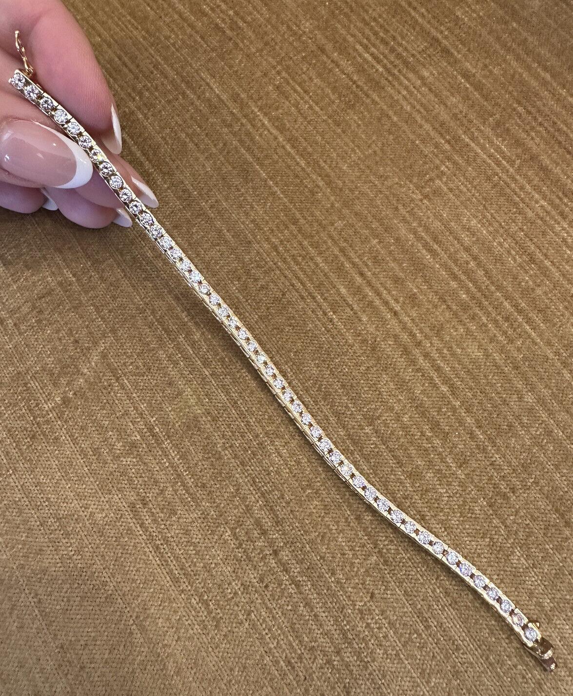 Round Diamond Tennis Line Bracelet 5.00 Carat Total Weight in 18k Yellow Gold 

Diamond Tennis Bracelet features one row of 47 Round Brilliant Diamonds that are set flush in a half bezel setting in 18k Yellow Gold. The bracelet is secured by a