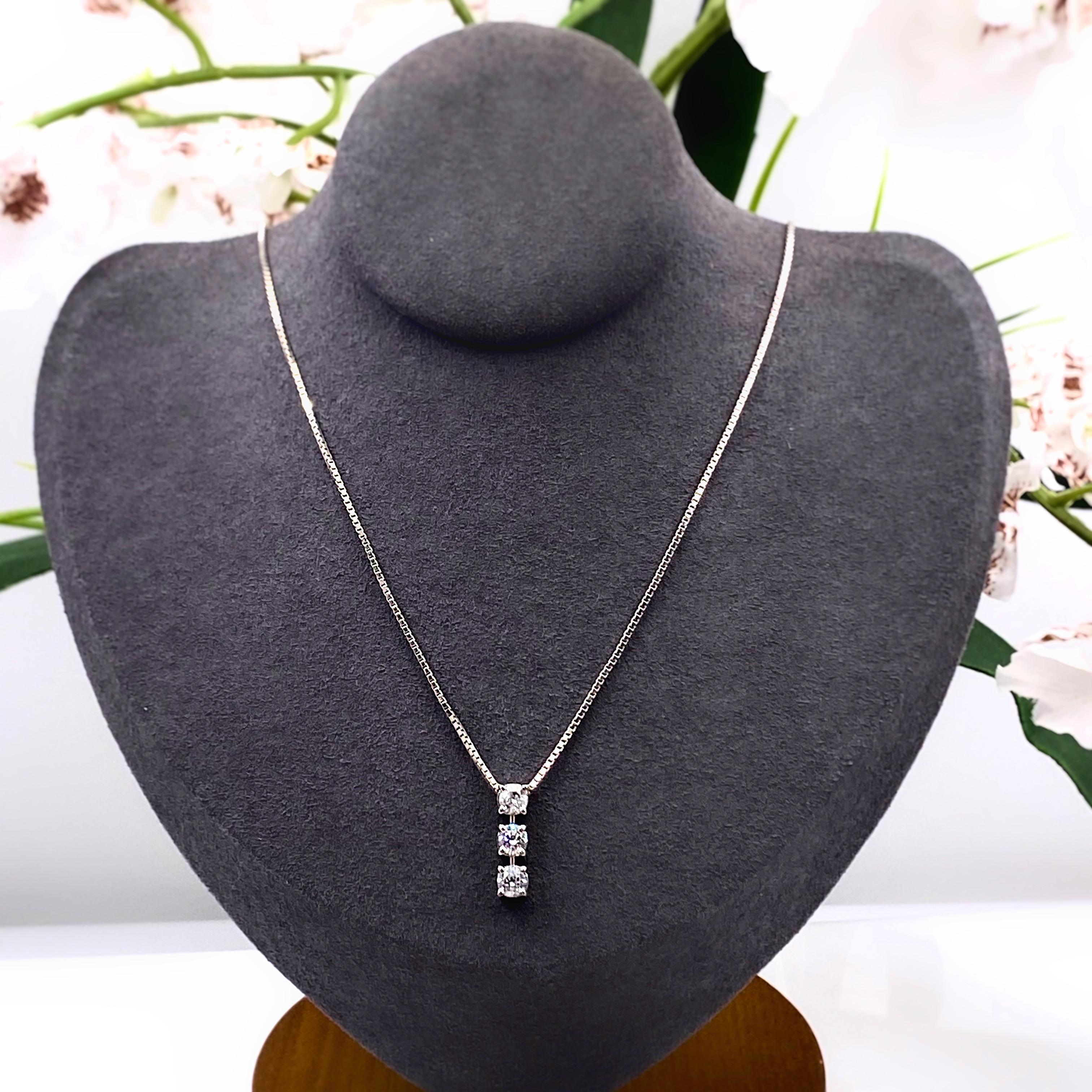 Round Diamond Three-Stone Pendant Necklace
Metal:  18kt White Gold
Length:  Chain 17.5 Inches
Pendant:  0.50 ( 1/2 ) Inches
TCW:  0.70 tcw
Main Diamond:  3 Round Brilliant Diamonds 0.19 cts - 0.23 cts - 0.28 cts
Color & Clarity: G - H / SI1 -