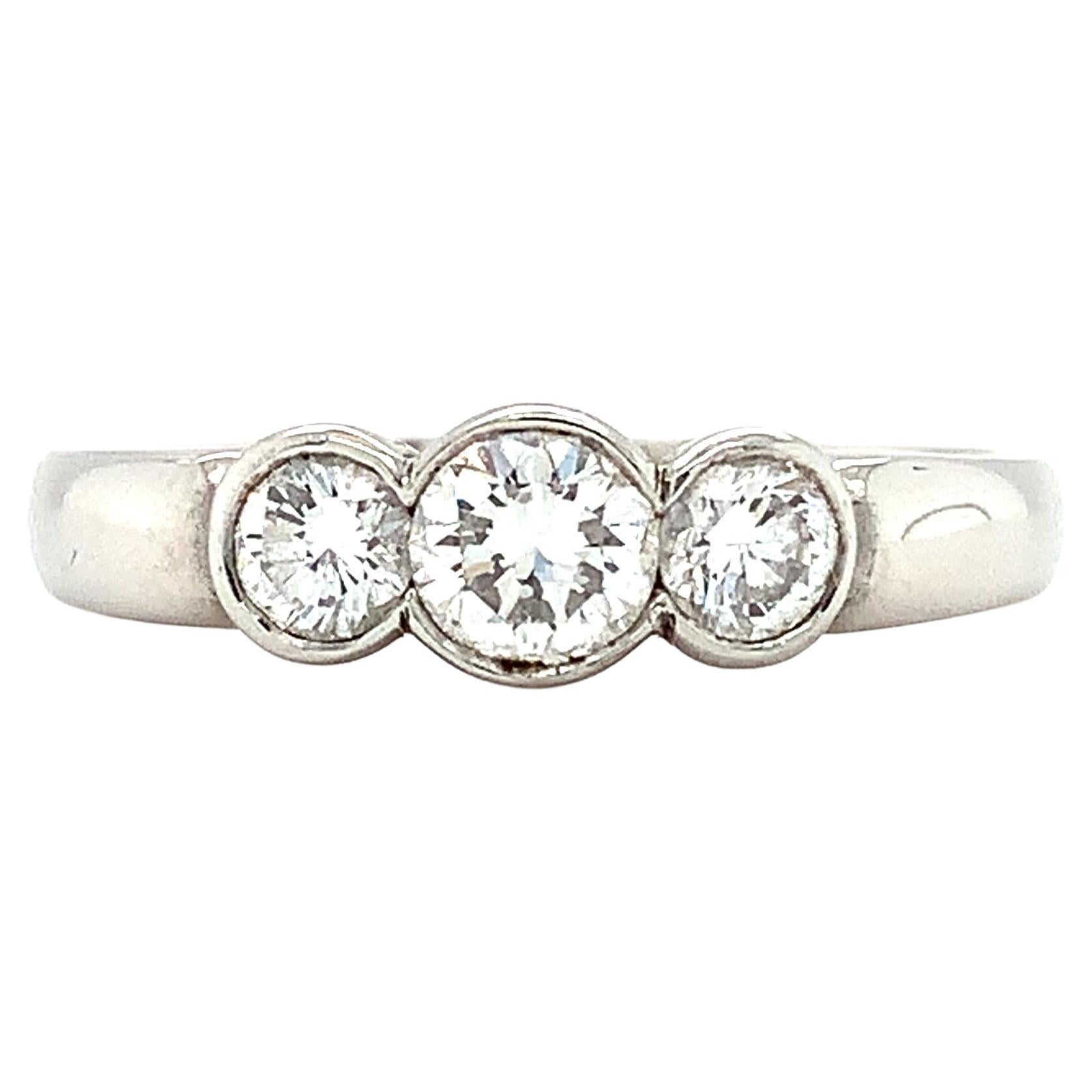 Round diamond three stone trilogy engagement ring platinum