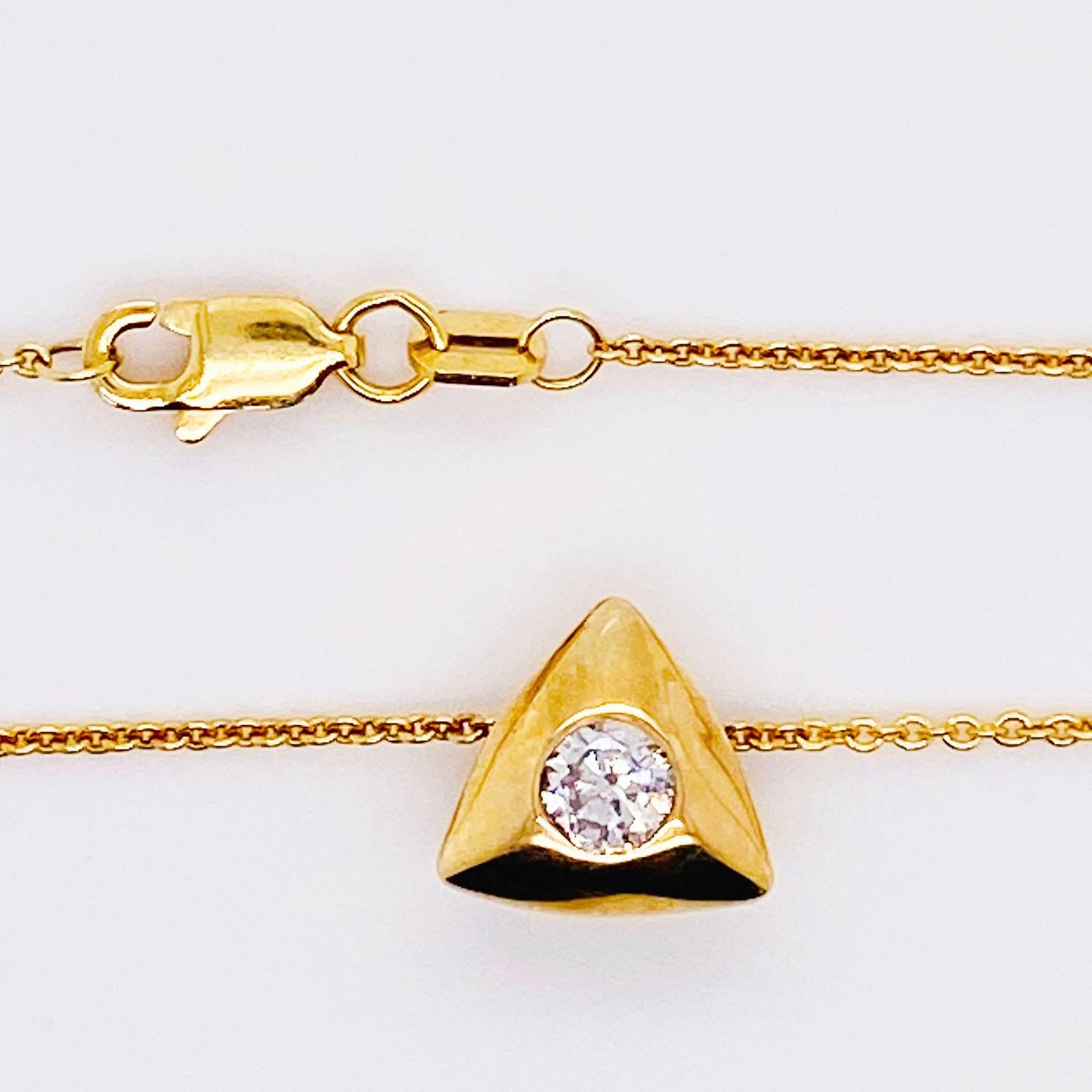 Modern diamond bezel pendant and chain. This necklace is a modern, 2020 design with a genuine, natural round brilliant diamond set in 14 karat yellow gold. The dainty but bold piece is a modern bezel design with a unique triangular shape. The