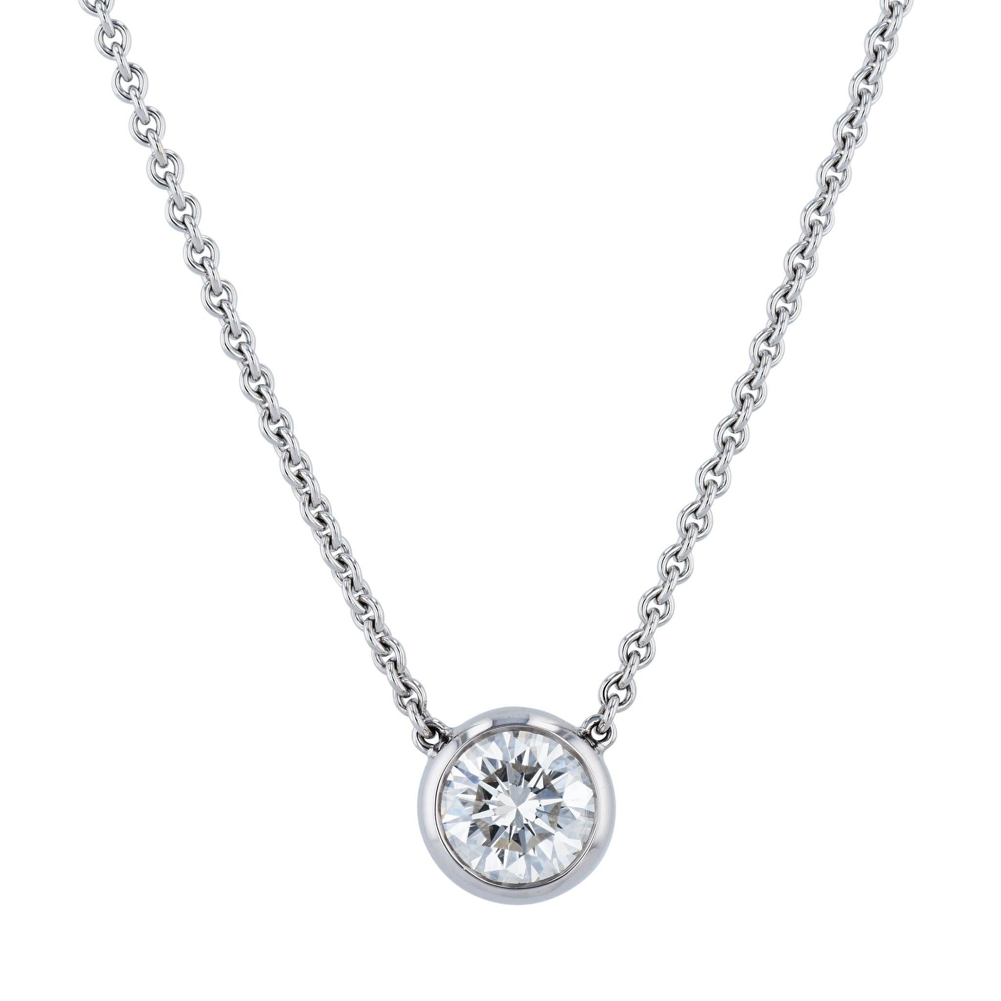 Treat yourself to an exquisite piece of jewelry with this Round Diamond White Gold Pendant Necklace! Crafted with 18K white gold with a Bezel-Set Diamond. This gorgeous necklace is further accented with a 16