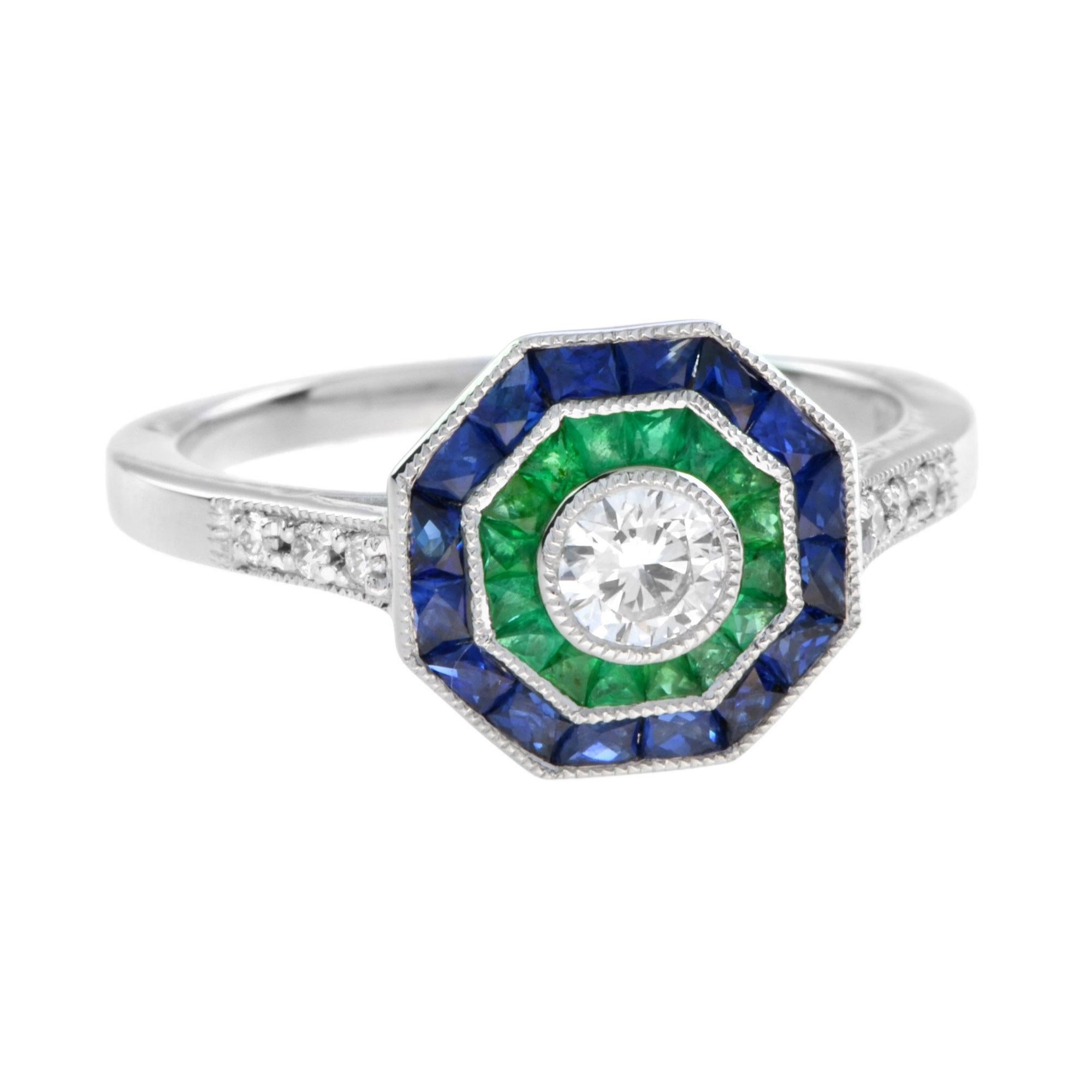 Exquisite early Art Deco Style Diamond and Emerald design ring. The central Diamond is surrounded by a band of finely set emeralds and sapphire to an outer band of Diamonds creating a chic octagonal form. 14K White Gold. 
Ring Information
Style: Art