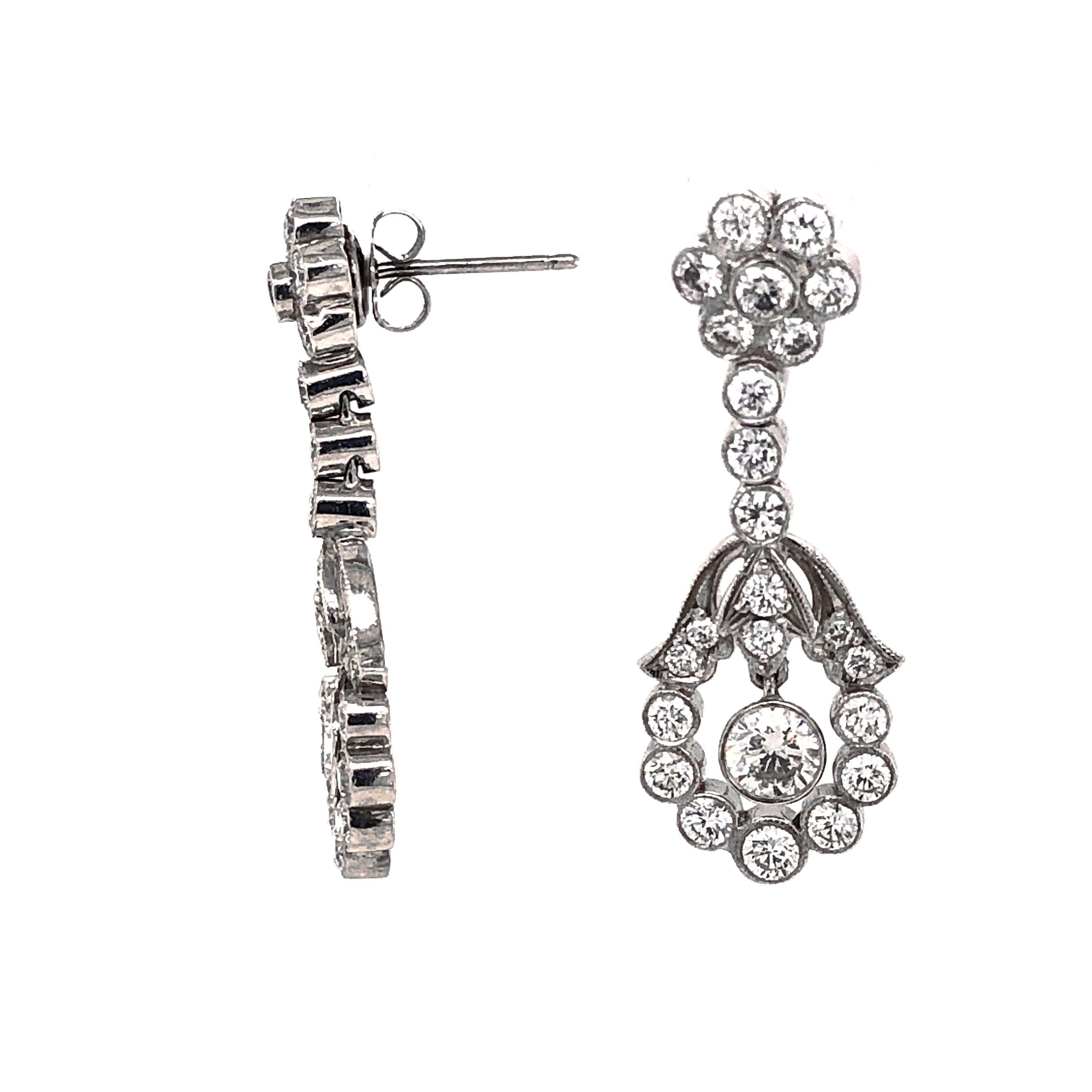 This dainty drop earrings holds round cut white diamonds 2.36 ct in total.
Diamonds are natural in G-H Color Clarity VS. 
Platinum 950 metal. 
Butterfly studs. 
Floral inspired design.
Width: 1.2 cm
Height: 3.5 cm
Weight: 11.47 g