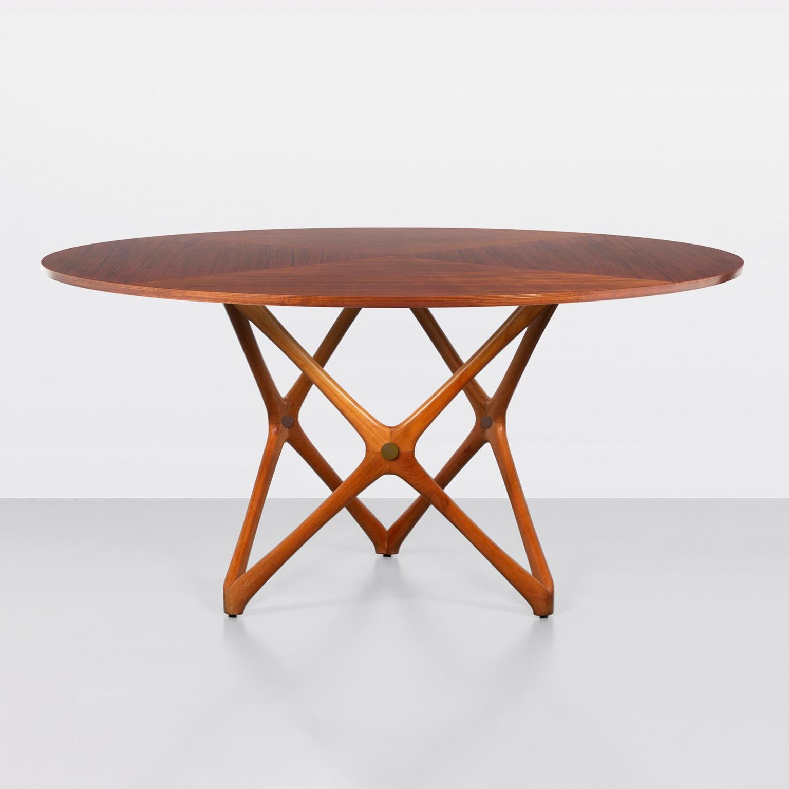 Round dining/center table, solid wood base structure, veneered wood top. Structural connections made of bronze. 
Custom-made, production time ca. 10 weeks