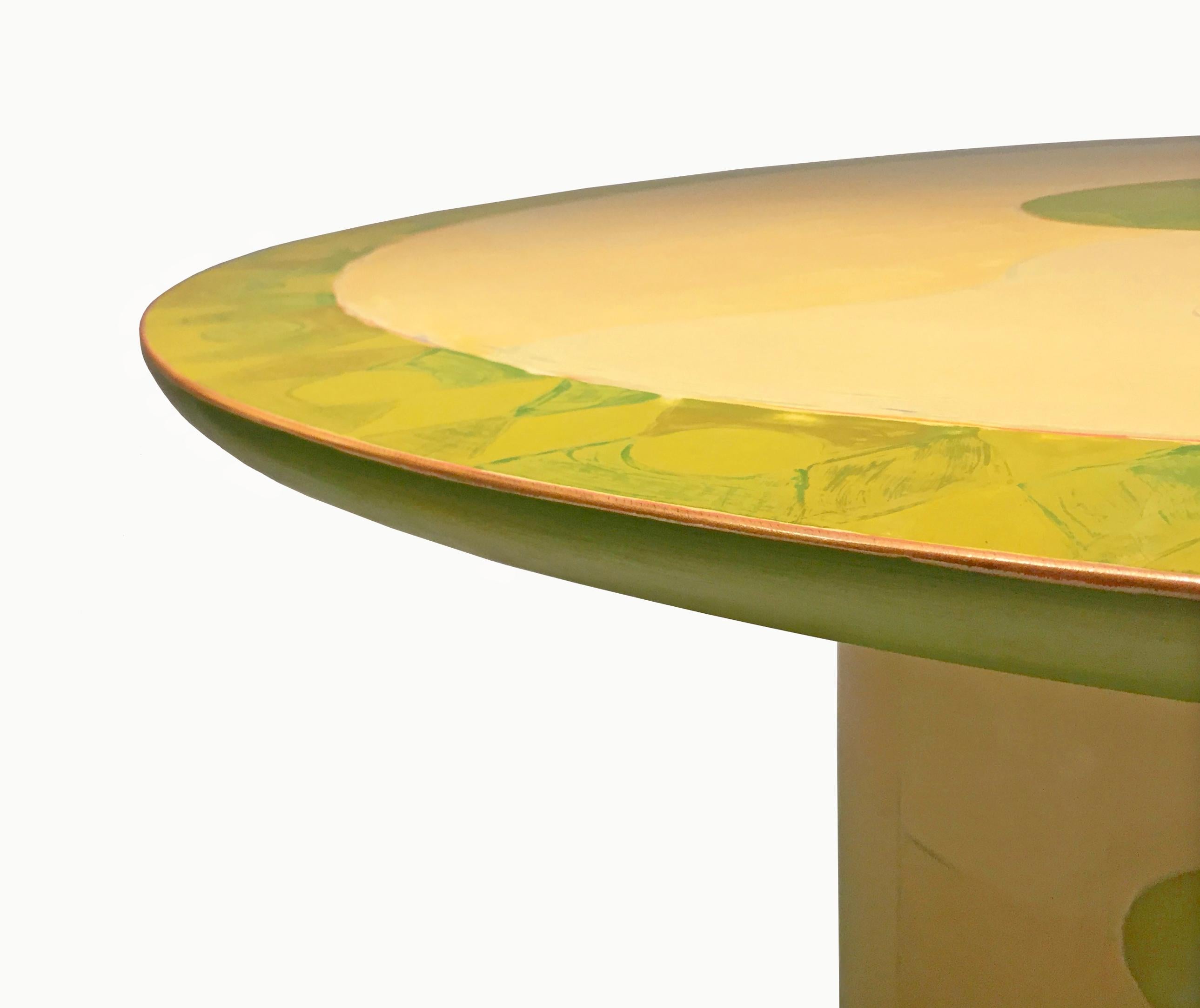 A unique, commissioned wooden dining centre table by artist and designer Randy Shull with a round, beveled top and a cylindrical base that has eight round plastic protective feet. The table is hand painted in approximately 50 layers, with sanding in