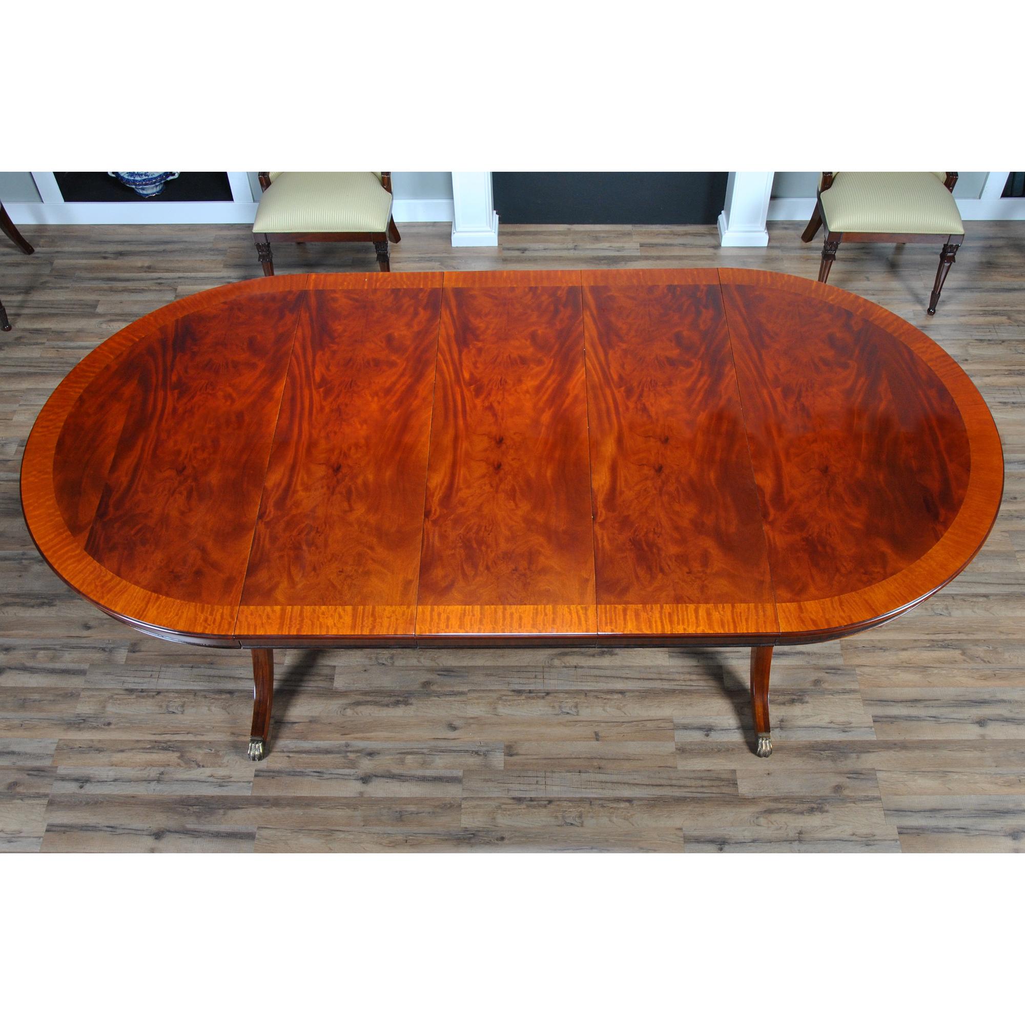 The Round Dining Table 60-115 inch is a high quality 60 inch round table when closed. The field of the table top being produced from the finest figural mahogany veneers and surrounded by satinwood banding and edged with a bull nose shaped molding.